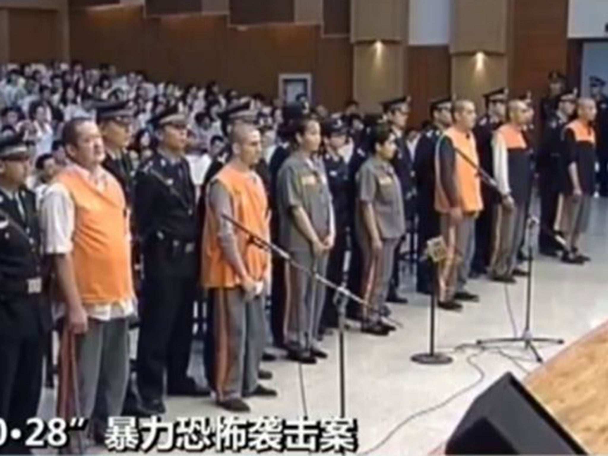 This screen grab taken from China Central Television shows the prisoners upon their arrival at the Intermediate People's Court in the Xinjiang capital, Urumqi