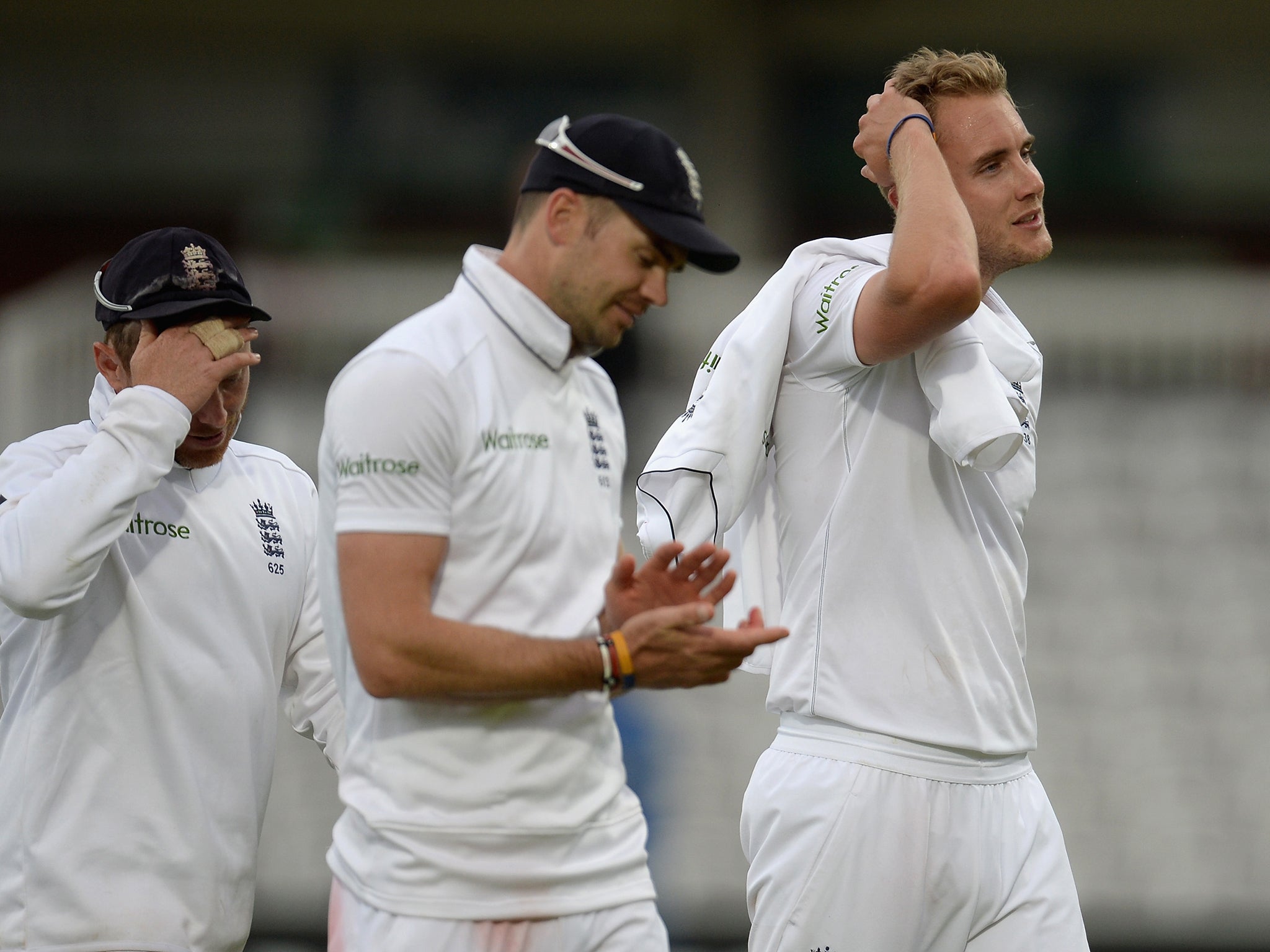 Ian Bell, James Anderson and Stuart Broad of England leave the field at Lord's after falling just short of beating Sri Lanka