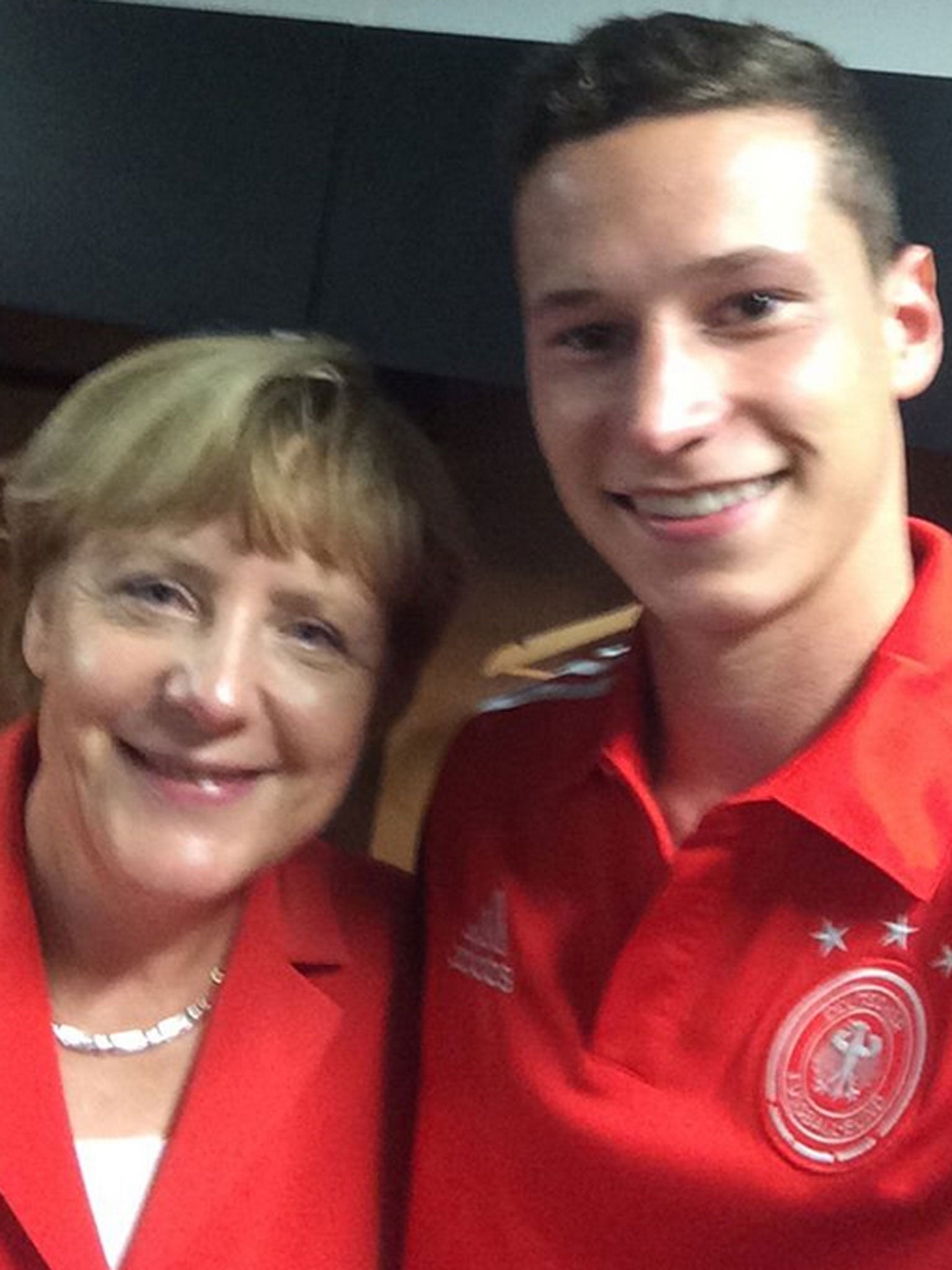 Merkel poses with young midfielder Julian Draxler