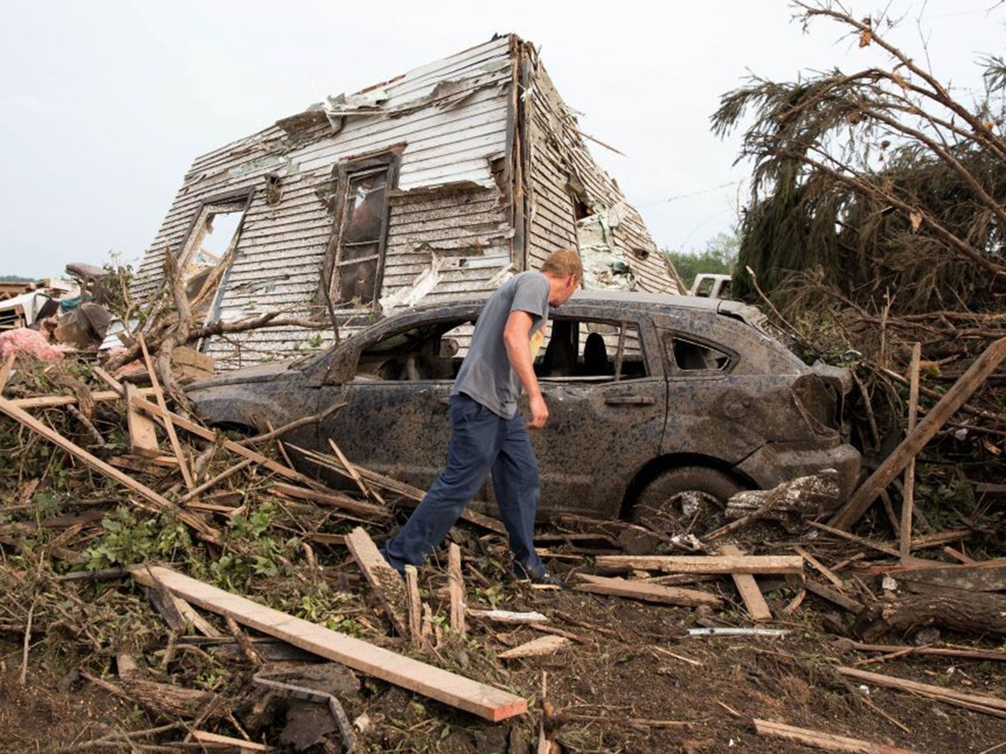 Tim Nelson searches for survivors in Pilger, Nebraska after the tornadoes hit