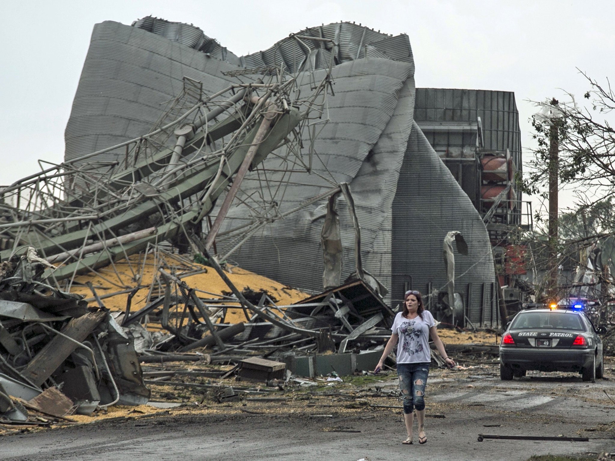 A woman walks down Black Hills Trail road in Pilger, Nebraska