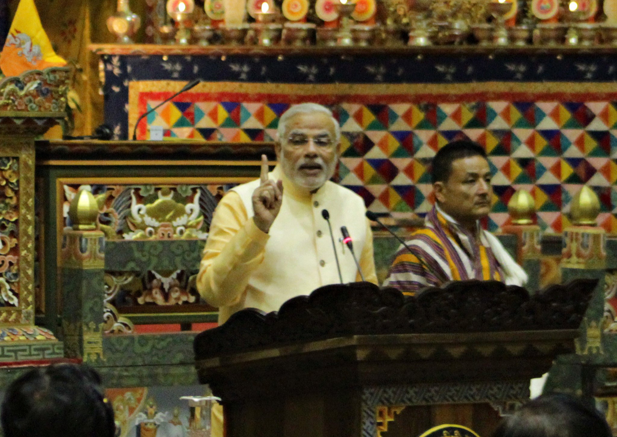 Bhutanese Bhunatese King Jigme Khesar Namgyel Wangchuck (L) and Indian Prime Minister Narendra Modi (R) shake hands during a photocall in Tashichhodzong on June 15, 2014.