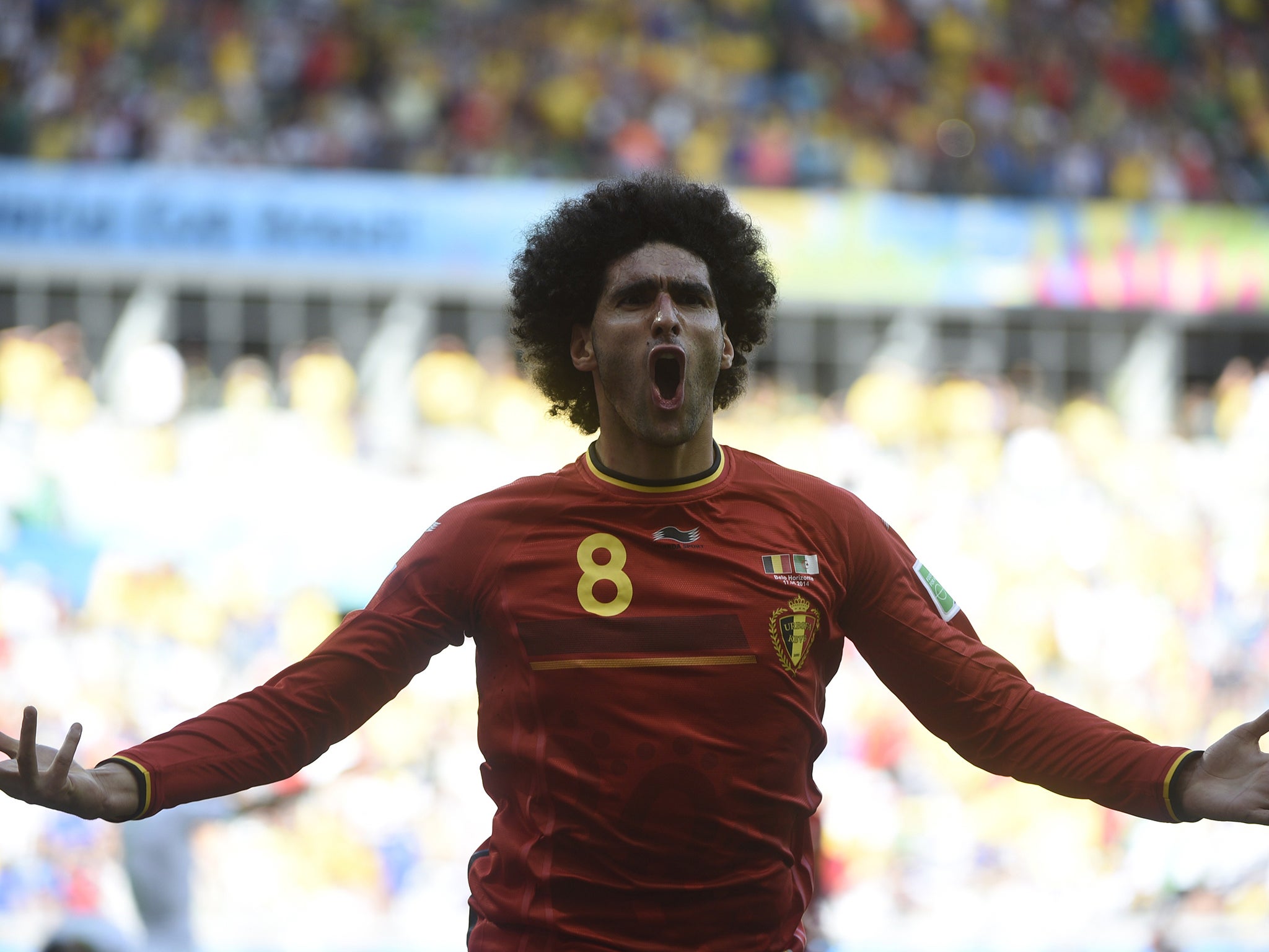 Marouane Fellaini celebrates bringing the scores level