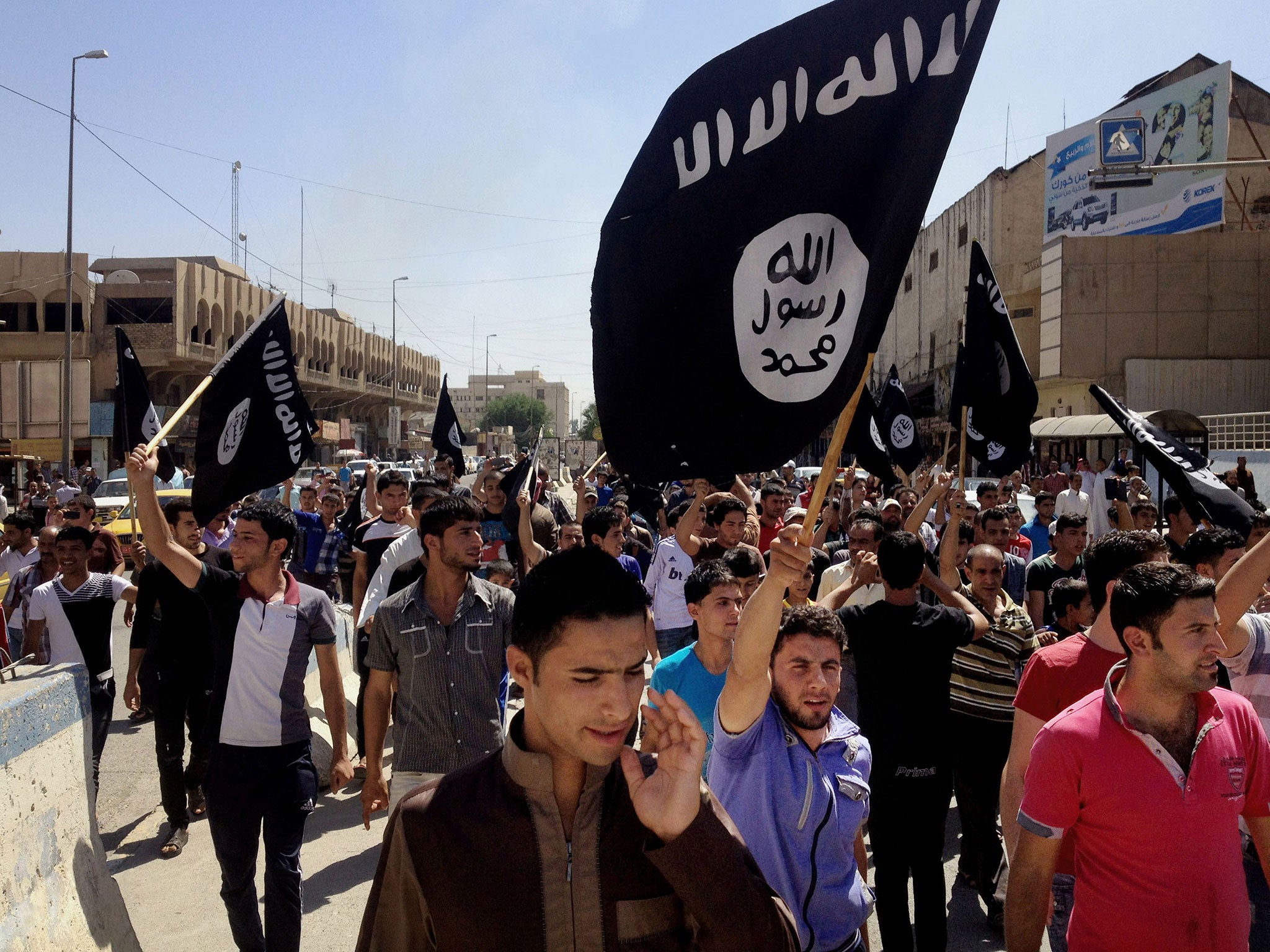 Demonstrators chant slogans as they carry al-Qa’ida flags