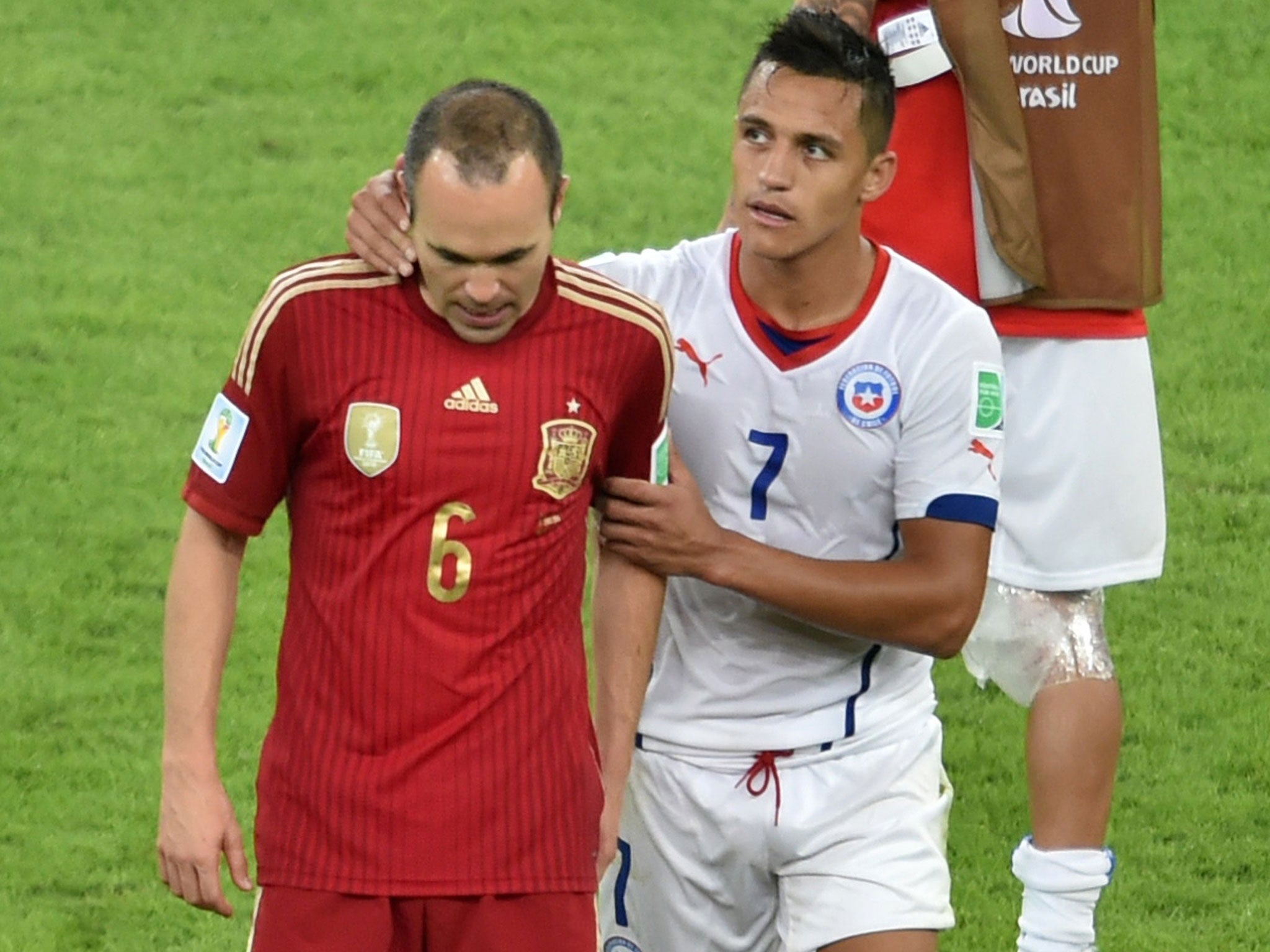 Alexis Sanchez (right) consoles his club-mate from Barcelona Andres Iniesta