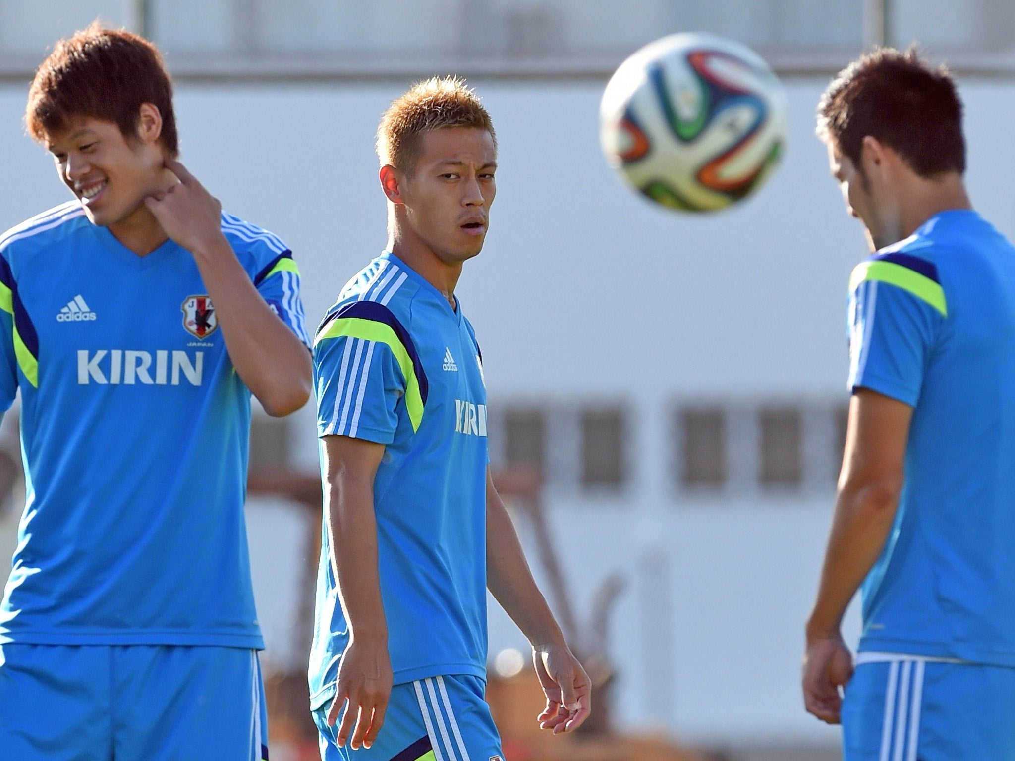 Japan's Keisuke Honda, centre, training with teammates