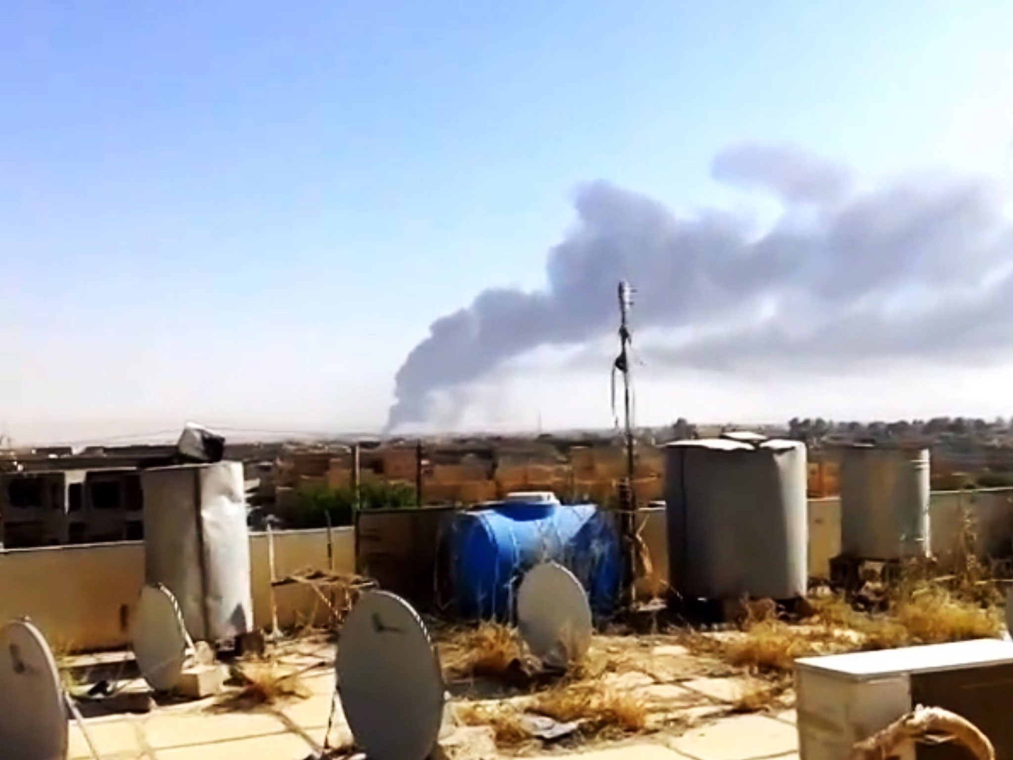 A smoke rises after an attack by Isis militants on Iraq's largest oil refinery north of the capital, Baghdad.