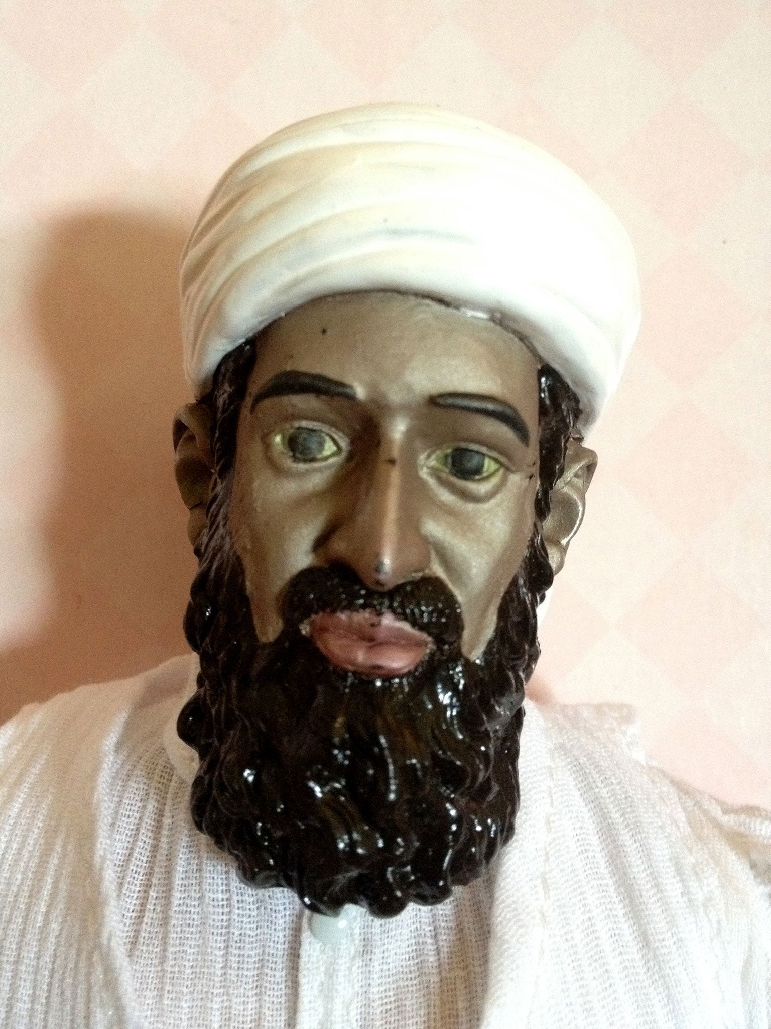 The faces of the figures were painted with a heat-dissolving material, designed to peel off and reveal a red-faced bin Laden.