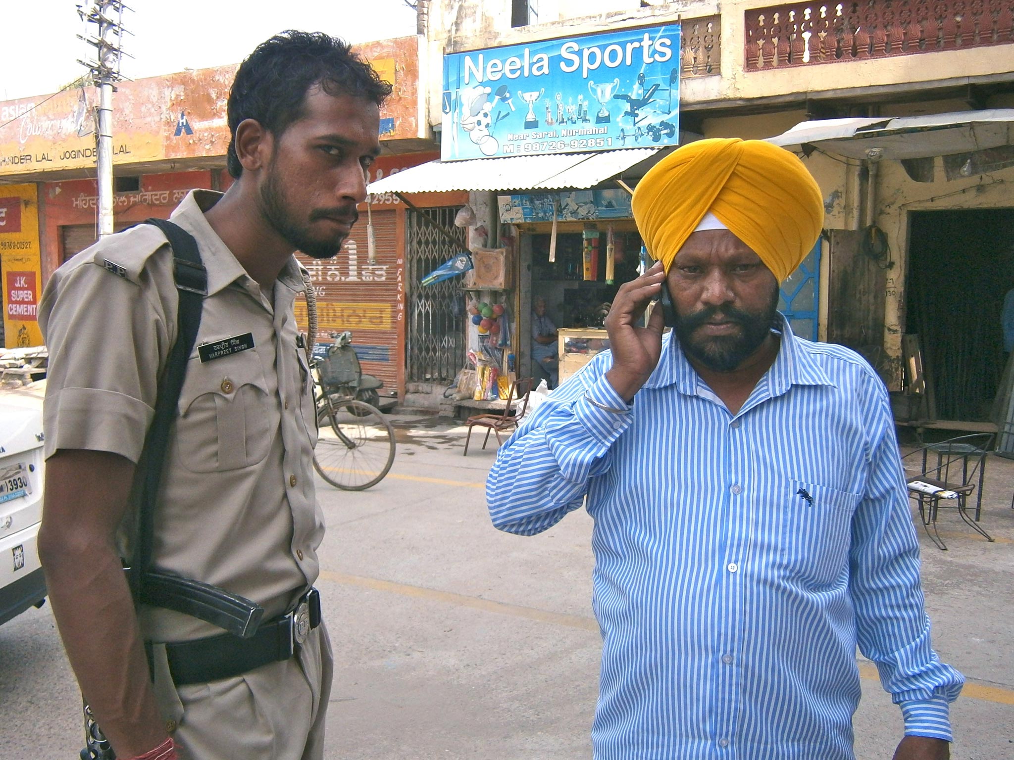 The guru's former driver Puran Singh (right) and his police bodyguard