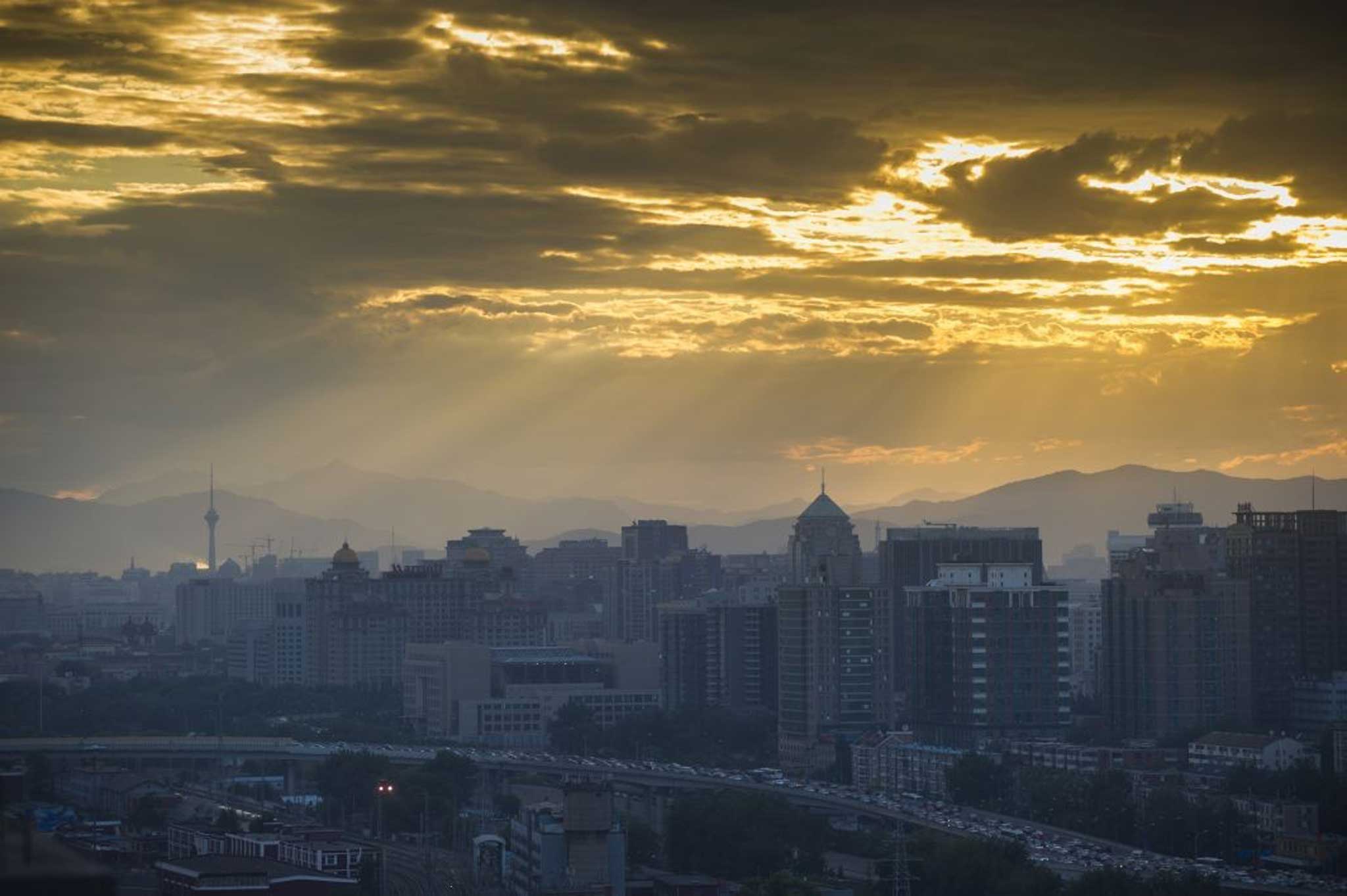 The skyline over Beijing shows traffic jams into the busy Chinese city, but slowing growth in the country has hit smaller companies
