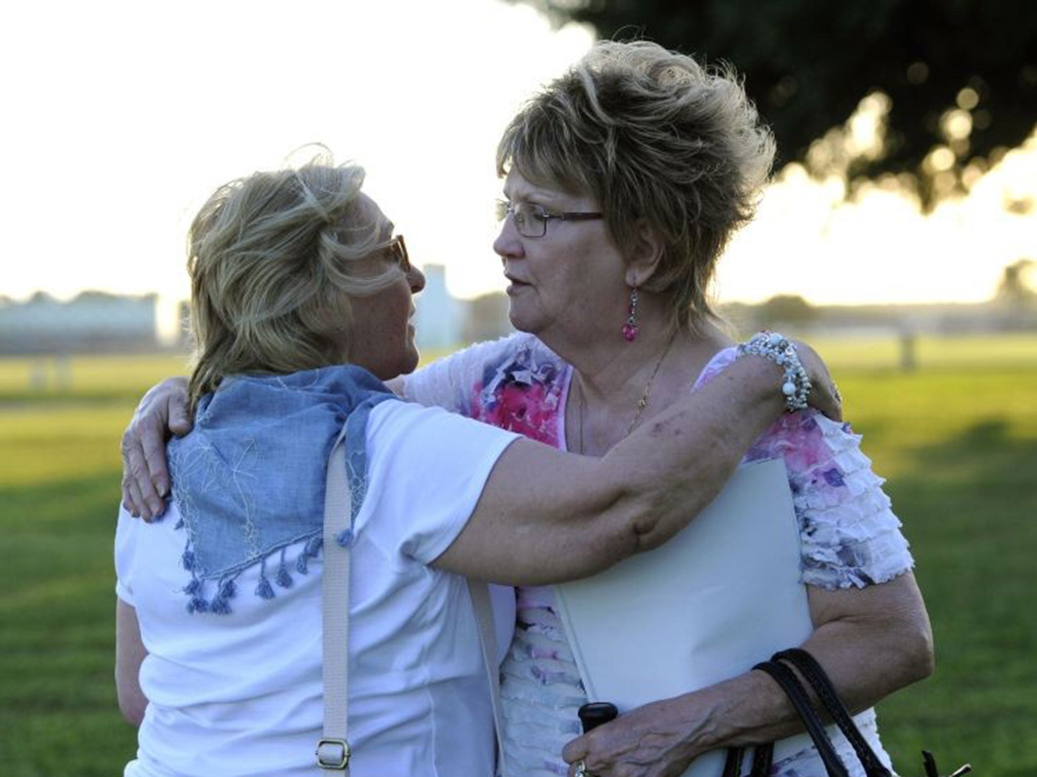 Joan Careford of England, left, hugs Rita Stewart, whose husband is on death row. Mrs Careford was a friend of John Henry