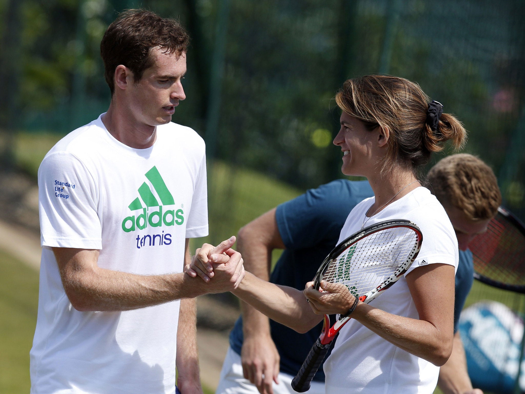 Murray and Mauresmo shake hands after a training session at the All England Tennis Club