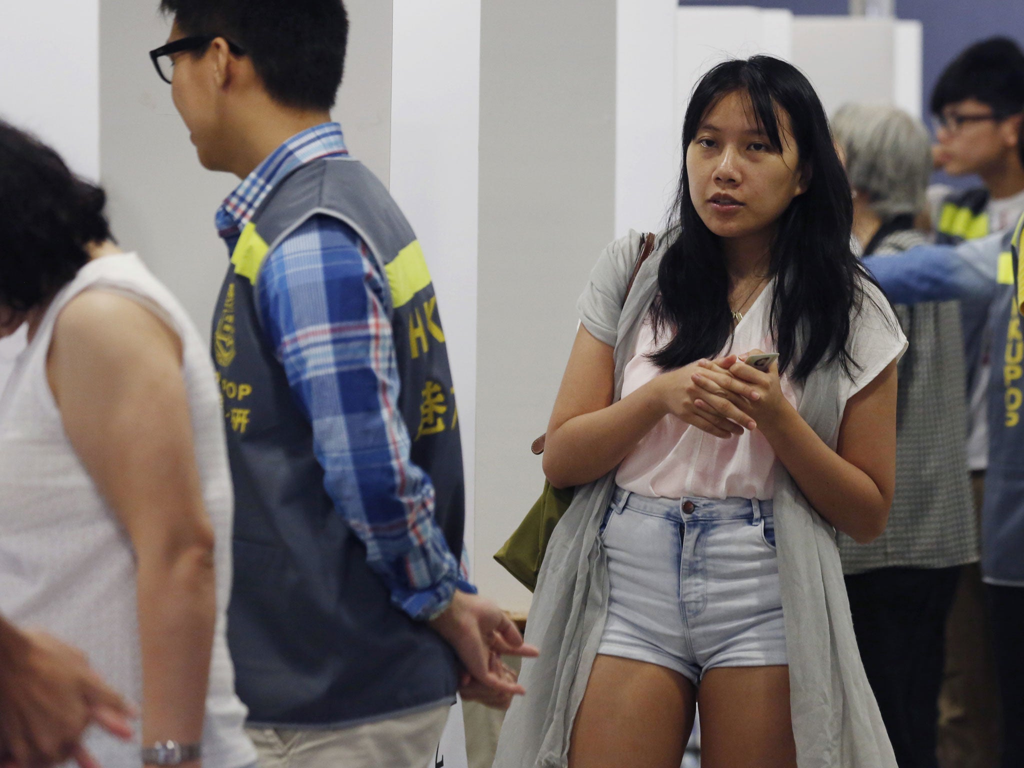 People vote in a polling station for an unofficial referendum on democratic reform in Hong Kong