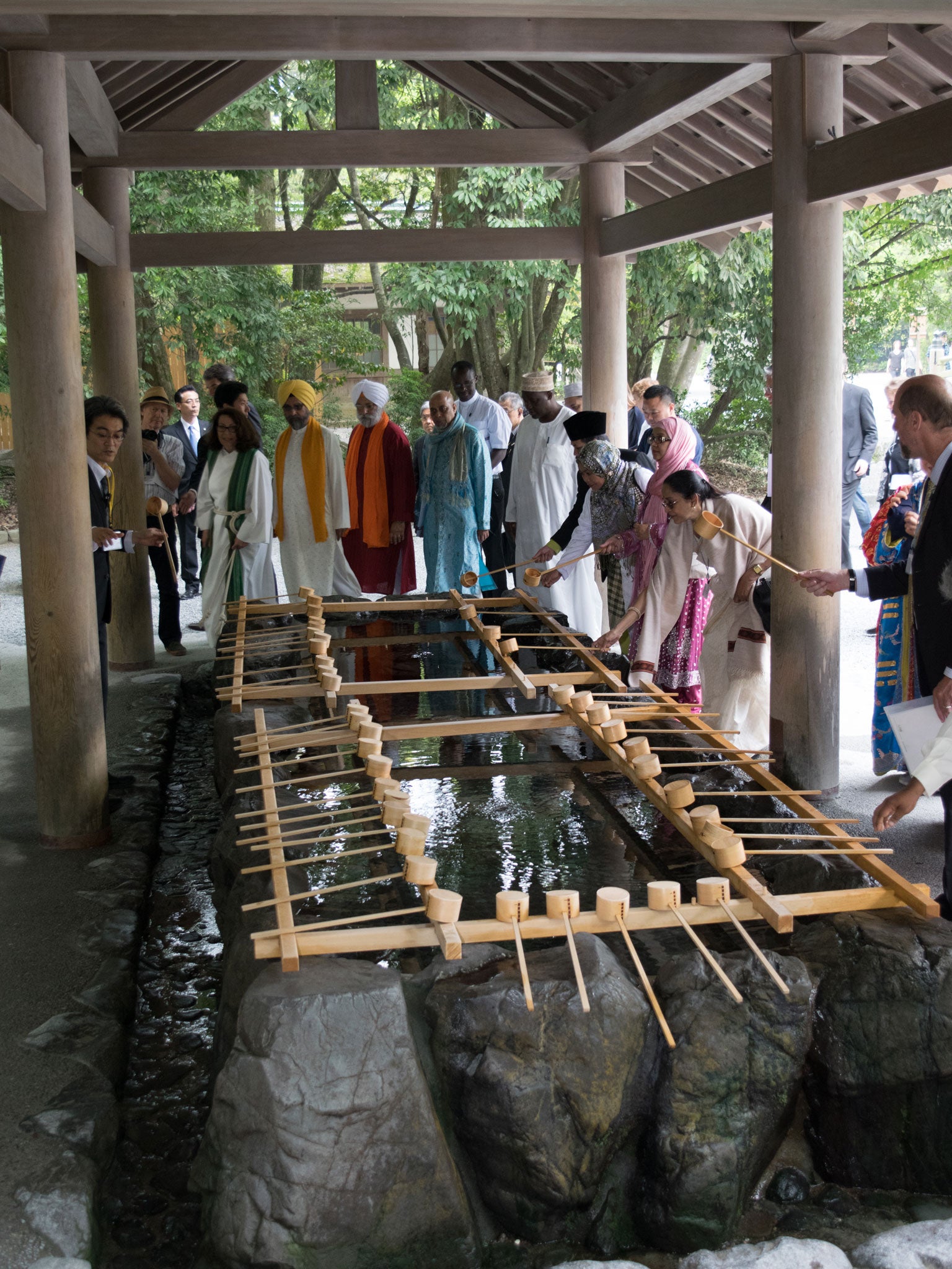 Foreign pilgrims perform ritual ablutions before entering the shrine