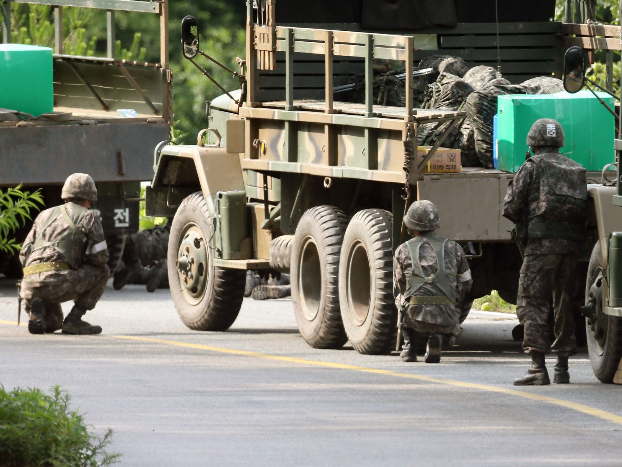 South Korean army soldiers take part in an operation to capture an armed deserter in an east coast hillside near the inter-Korean border in Goseong, Gangwon Province, South Korea, 23 June 2014