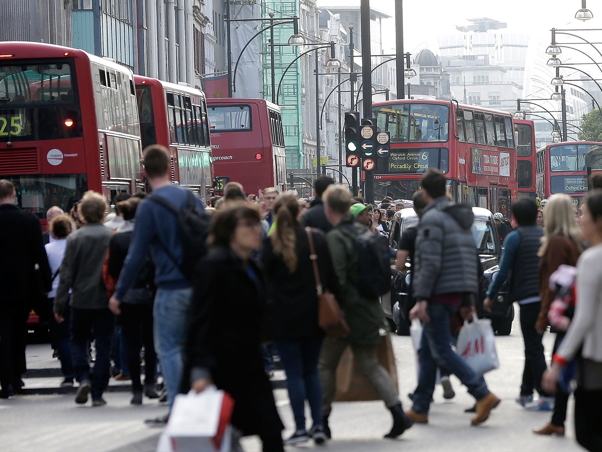 A general view of Oxford Street as commuters attempt to board buses whilst crowds flock to Oxford St