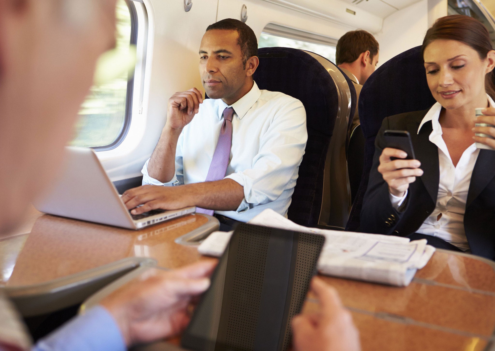 Commuters using their phones