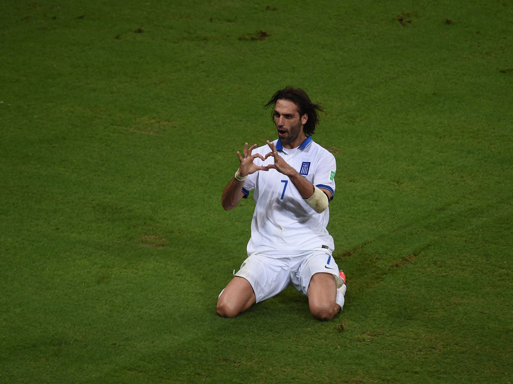 Greece's forward Georgios Samaras celebrates scoring a penalty