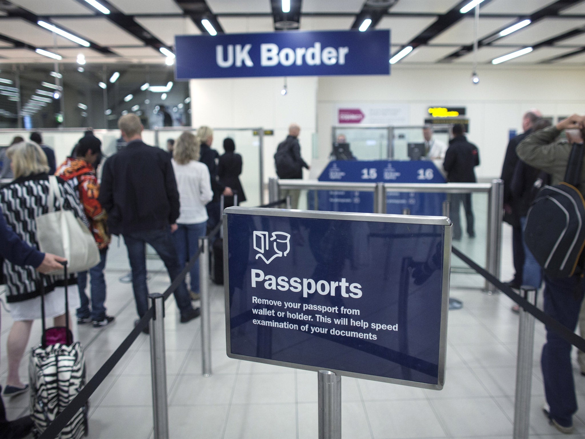 Border Force check the passports of passengers arriving at Gatwick Airport (Getty)