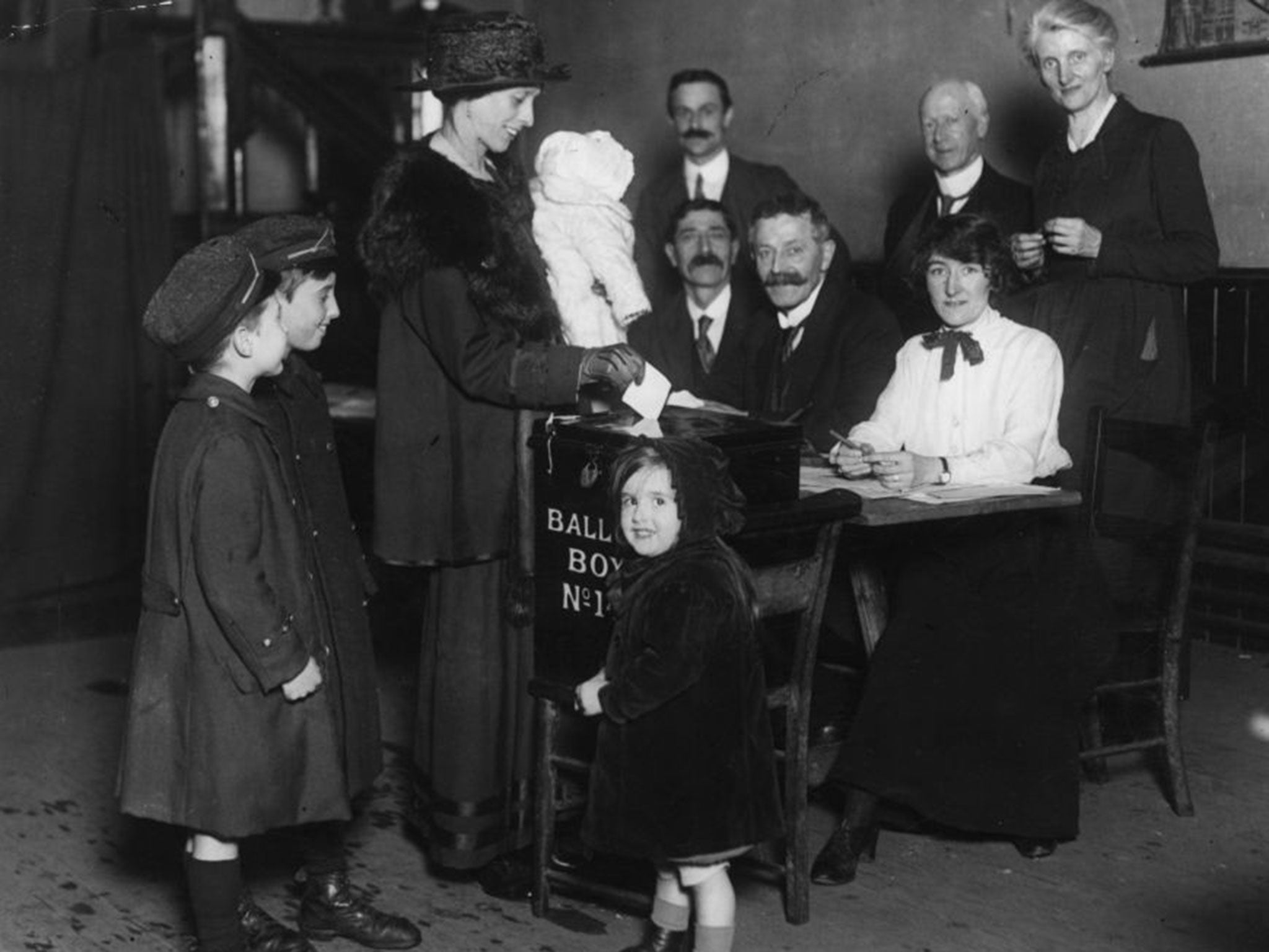 A newly enfranchised woman votes for the first time in 1918 (Getty)