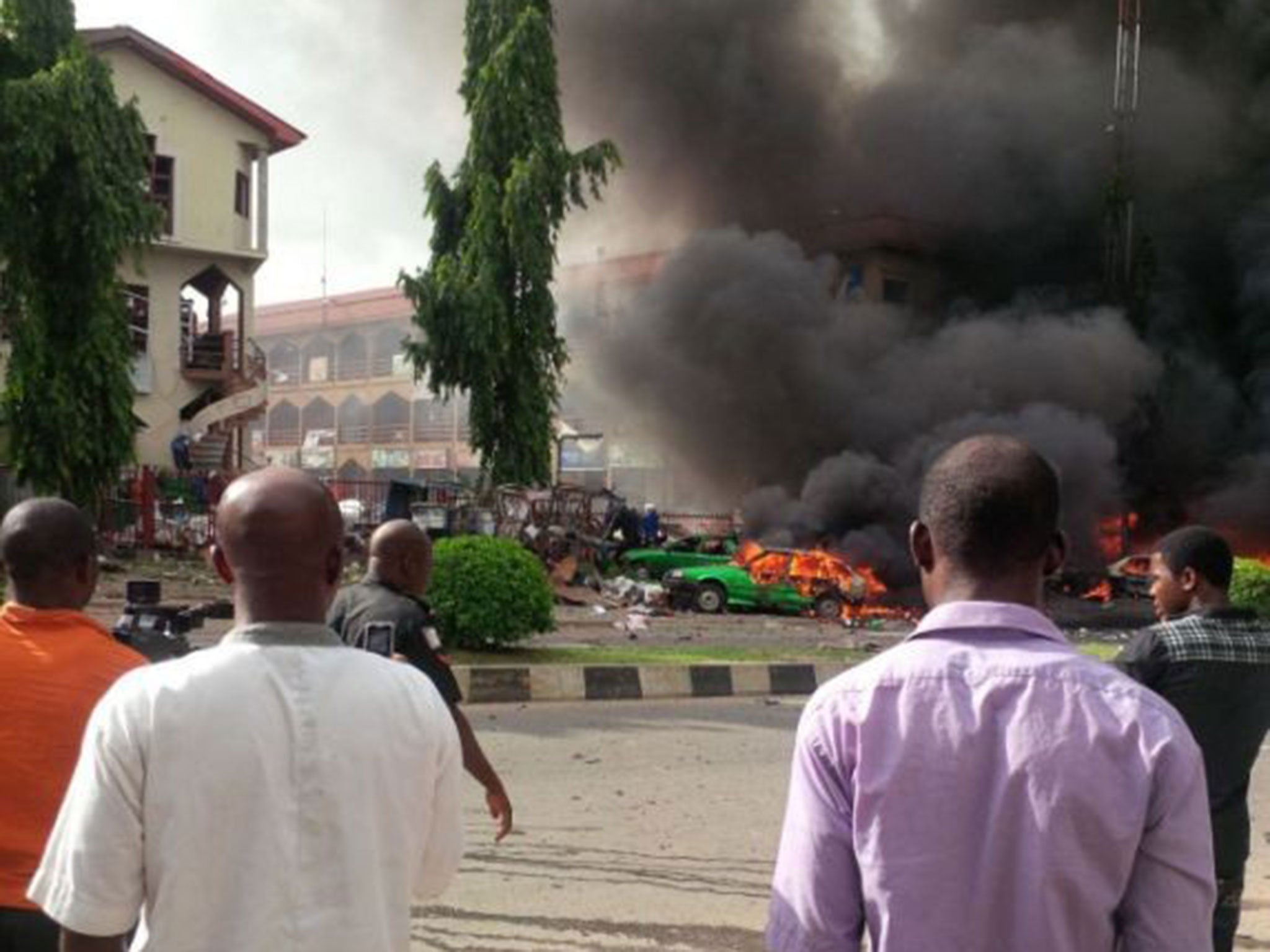 People watch as smoke fills the sky after the explosion.