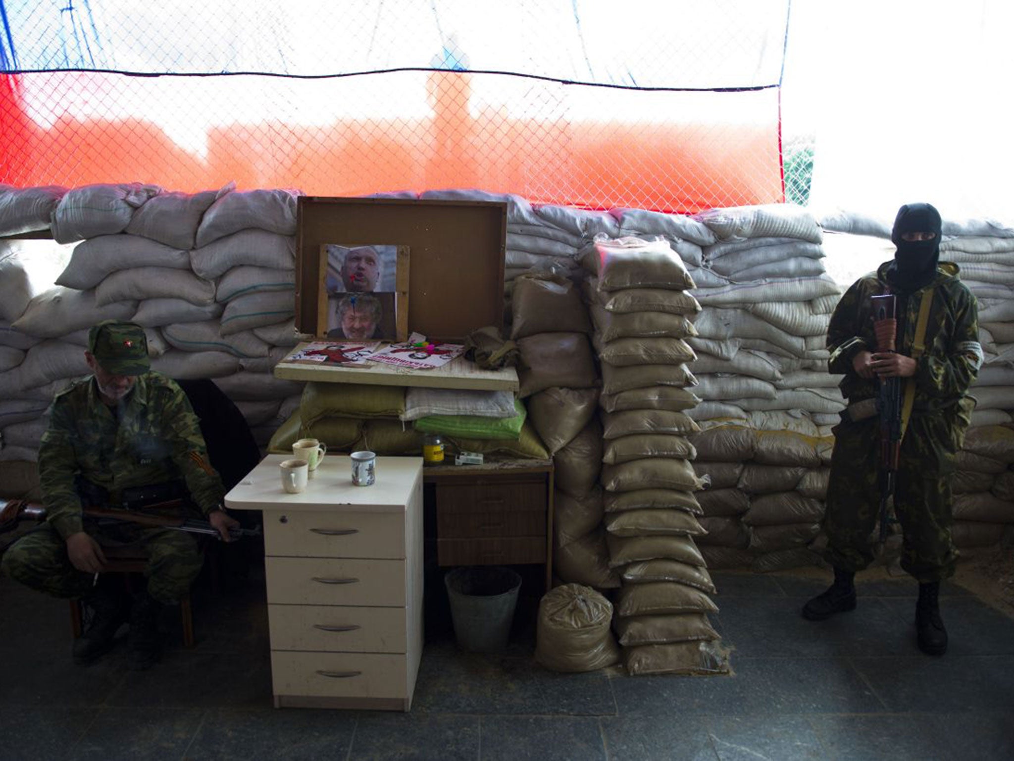 Guards of the self-proclaimed Donetsk People’s Republic keep watch in the town hall of the besieged eastern Ukrainian city of Slovyansk this week