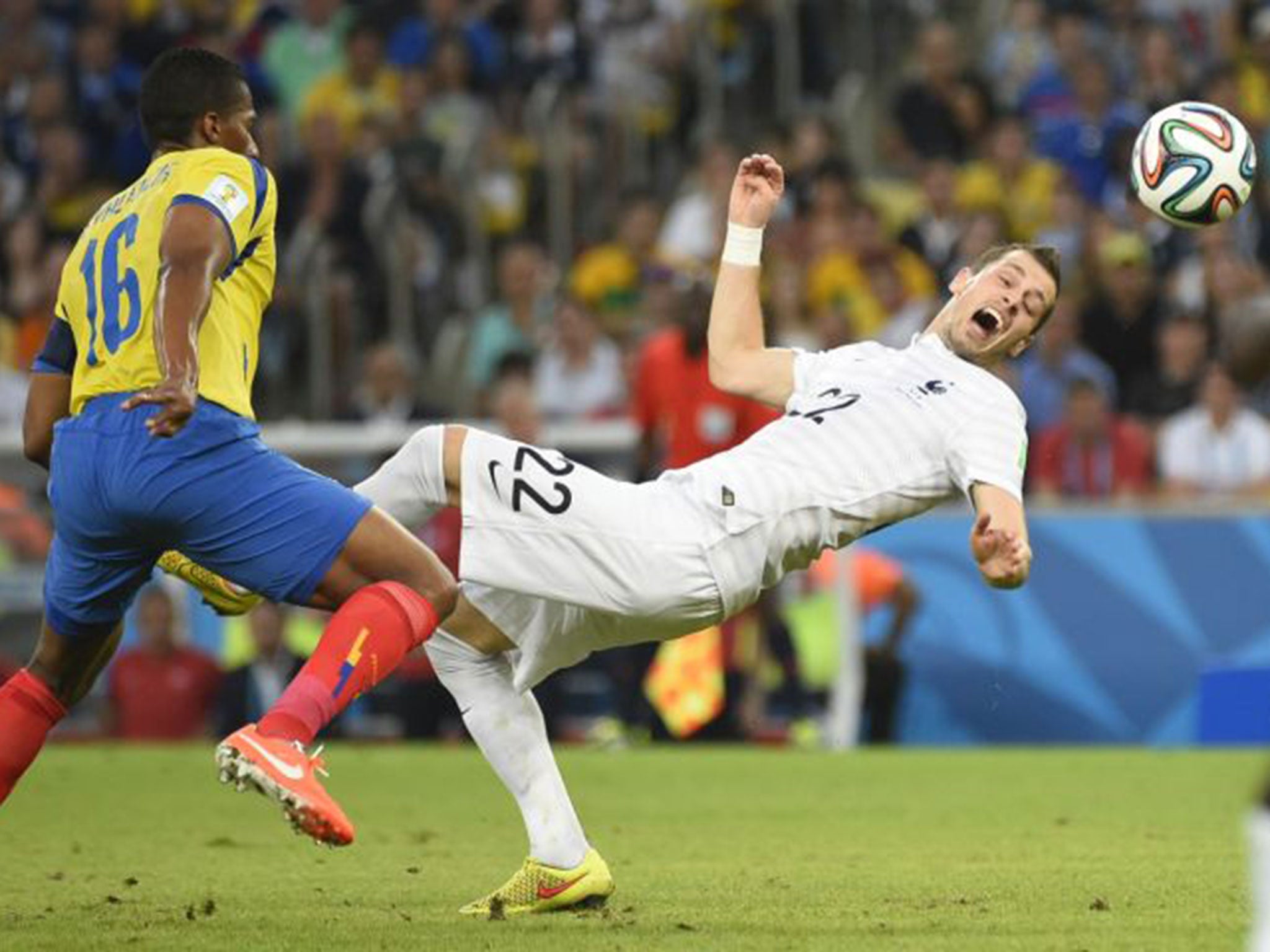 France's Morgan Schneiderlin is challenged by Ecuador's Antonio Valencia at the Maracana