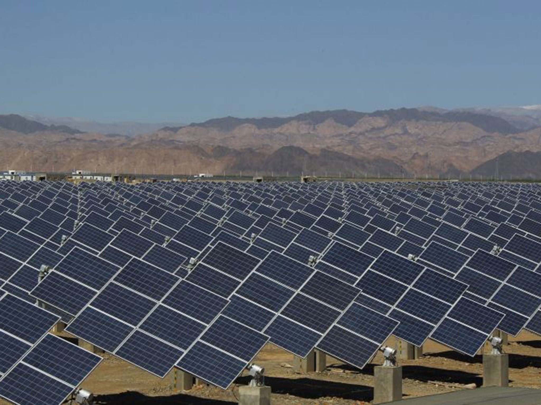 Large solar panels are seen in a solar power plant in Hami, northwest China's Xinjiang Uygur Autonomous region
