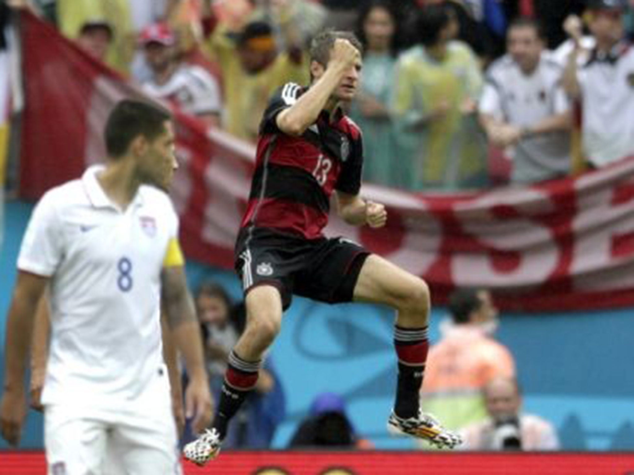 Germany's Thomas Mueller celebrates after scoring his side's first goal during the group G World Cup soccer match between the United States and Germany