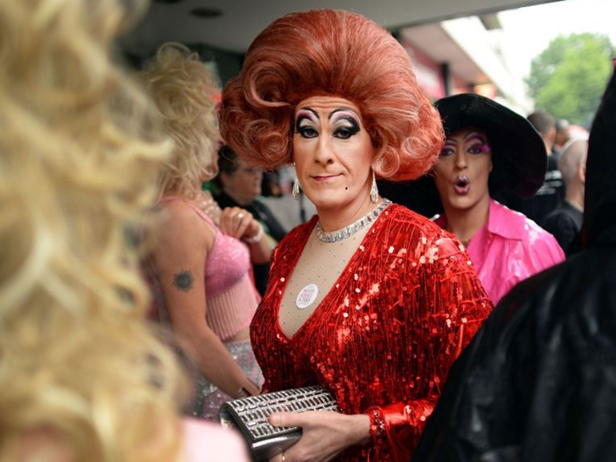 Two people take shelter during Pride, which saw a mixture of sunny spells and downpours of rain