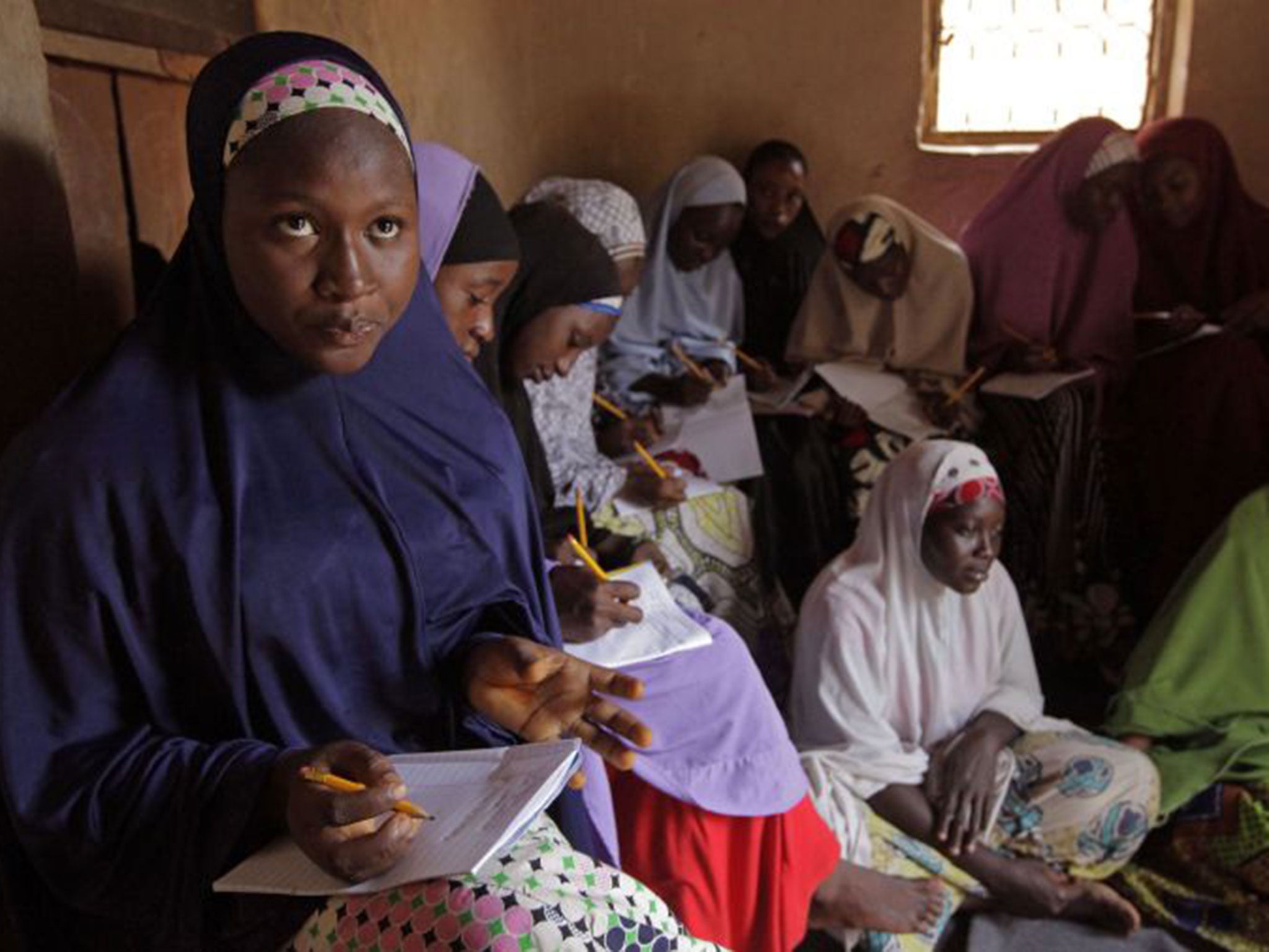 Maimuna Abdullah, left, is now able to go to school in Kaduna after running away from her violent forced marriage. Both her husband and her father had beaten her for disobeying them