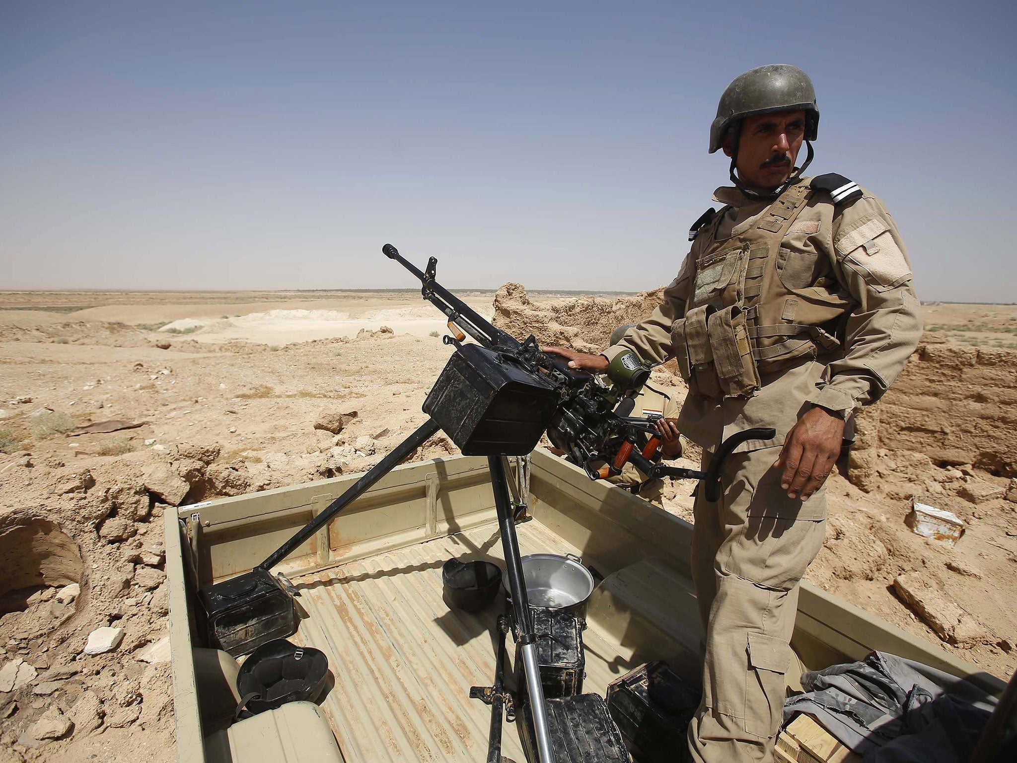 An Iraqi soldier monitors a street west of the shrine city of Karbala, in central Iraq