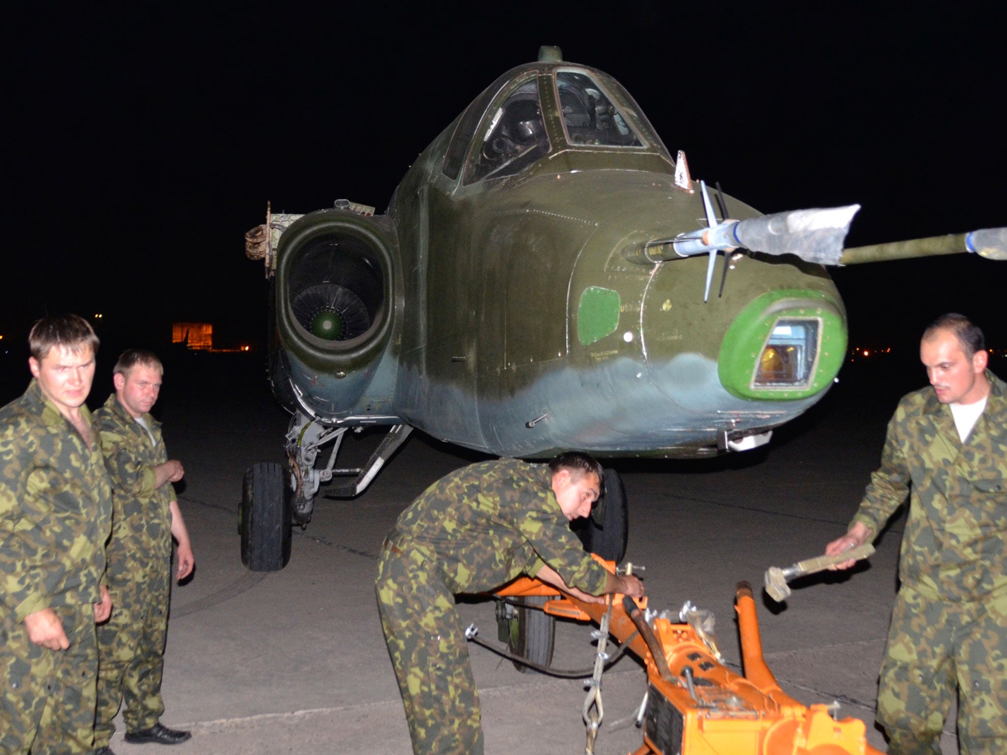 Russian soldiers unload one of three Sukhoi SU-25 fighter jets that were delivered to Baghdad over the weekend to help Iraqi forces take on the Isis radicals