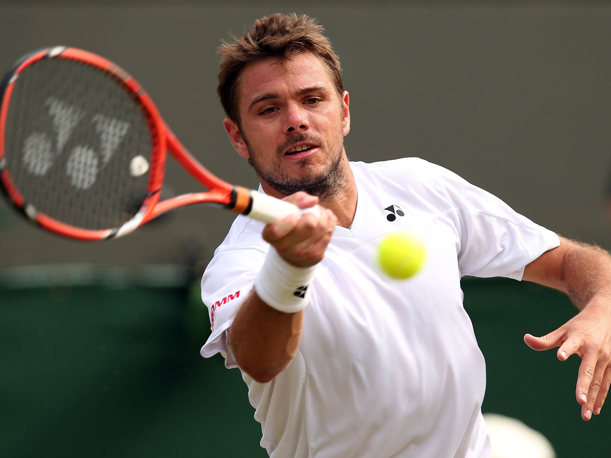 Switzerland's Stanislas Wawrinka returns to Taiwan's Lu Yen-Hsun during their men's singles second round match on day four of the 2014 Wimbledon