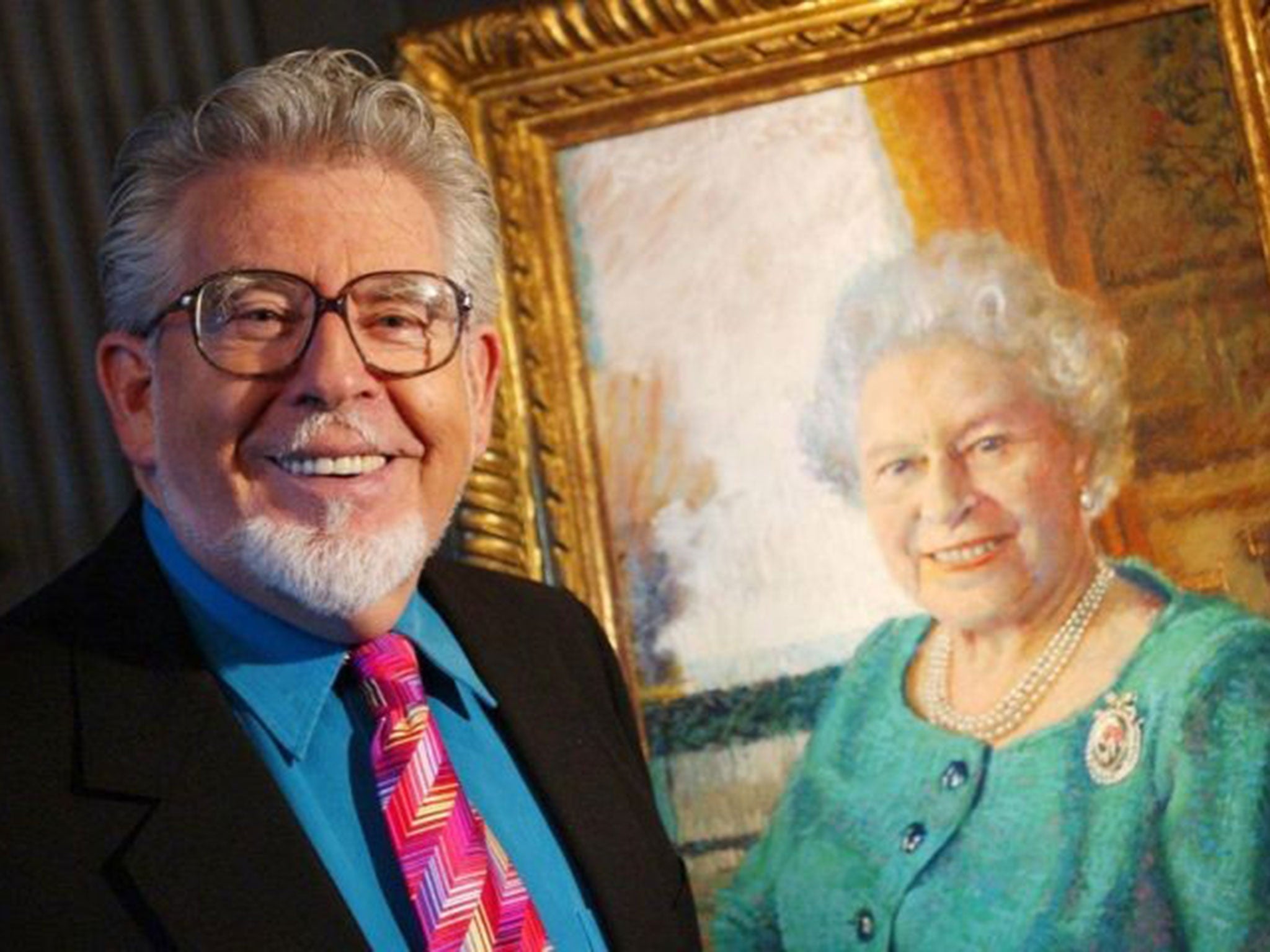 November 2006: Rolf Harris with his portrait of the Queen. She will have the final say on whether the disgraced artist and performer loses his honours, which have included an MBE, OBE and CBE