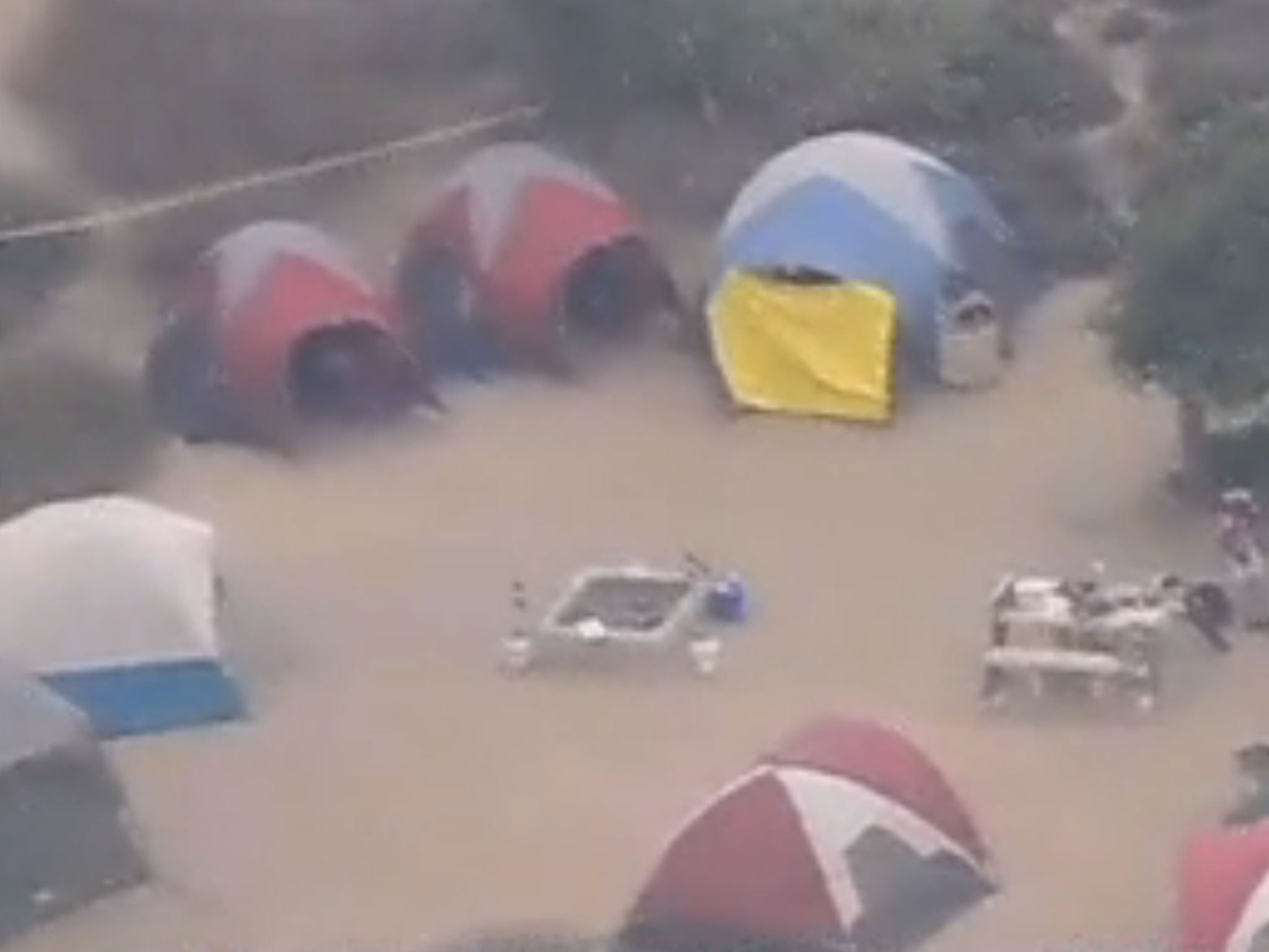 San Diego Six News aerial footage screengrab shows the scene of the shooting, with the blue tent in question covered by a yellow tarpaulin