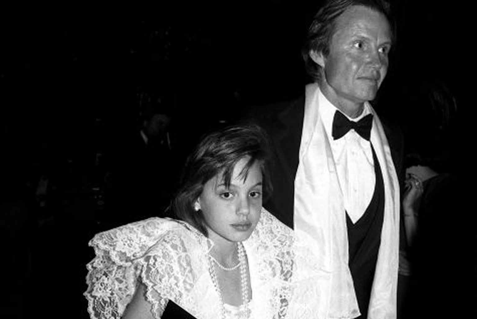 Angelina Jolie and Jon Voight attend a premiere in 1986