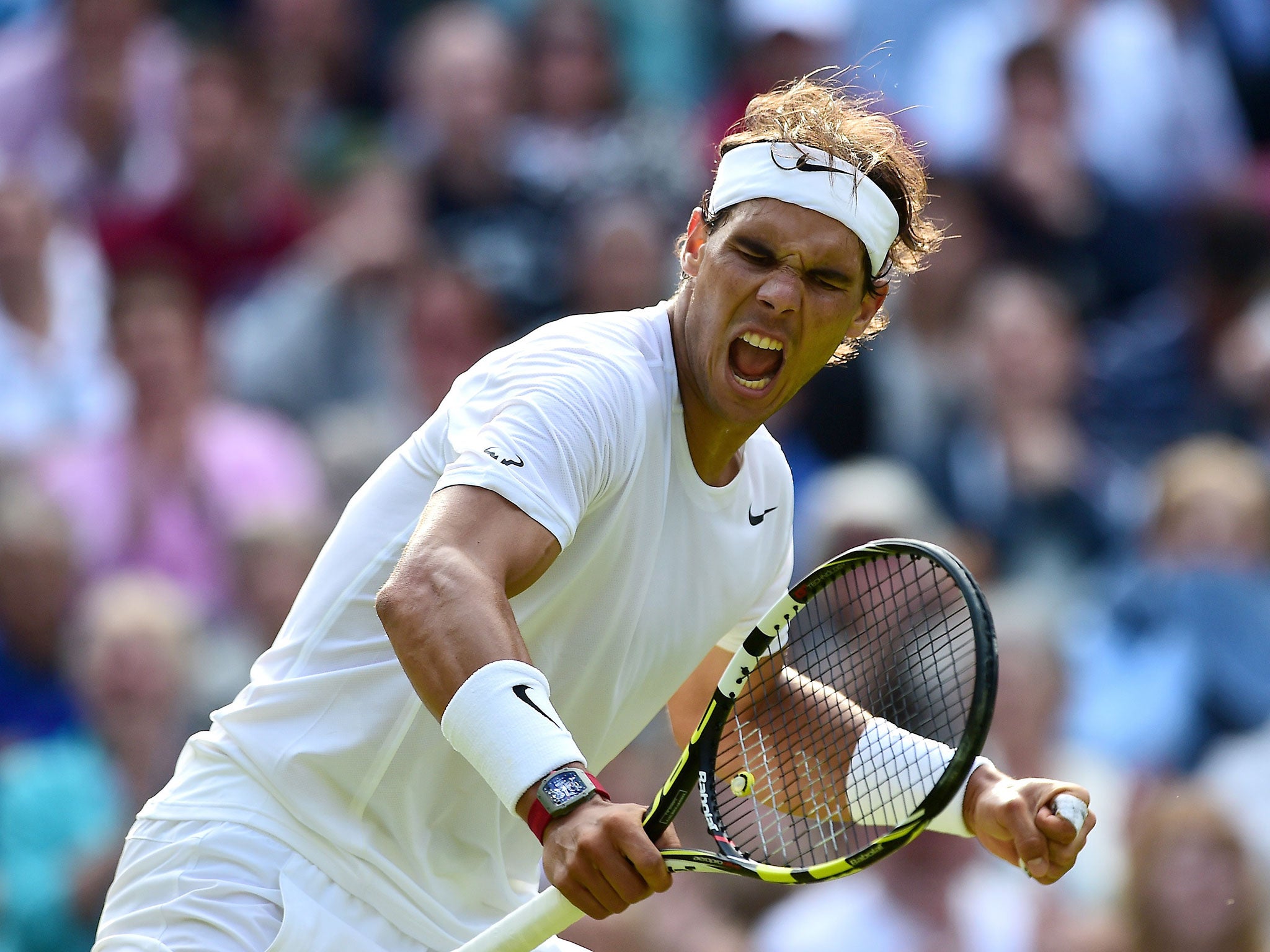 Spain's Rafael Nadal celebrates winning the second set against Australia's Nick Kyrgios during their men's singles fourth round match on day eight of the 2014 Wimbledon Championships at The All England Tennis Club in Wimbledon, southwest London