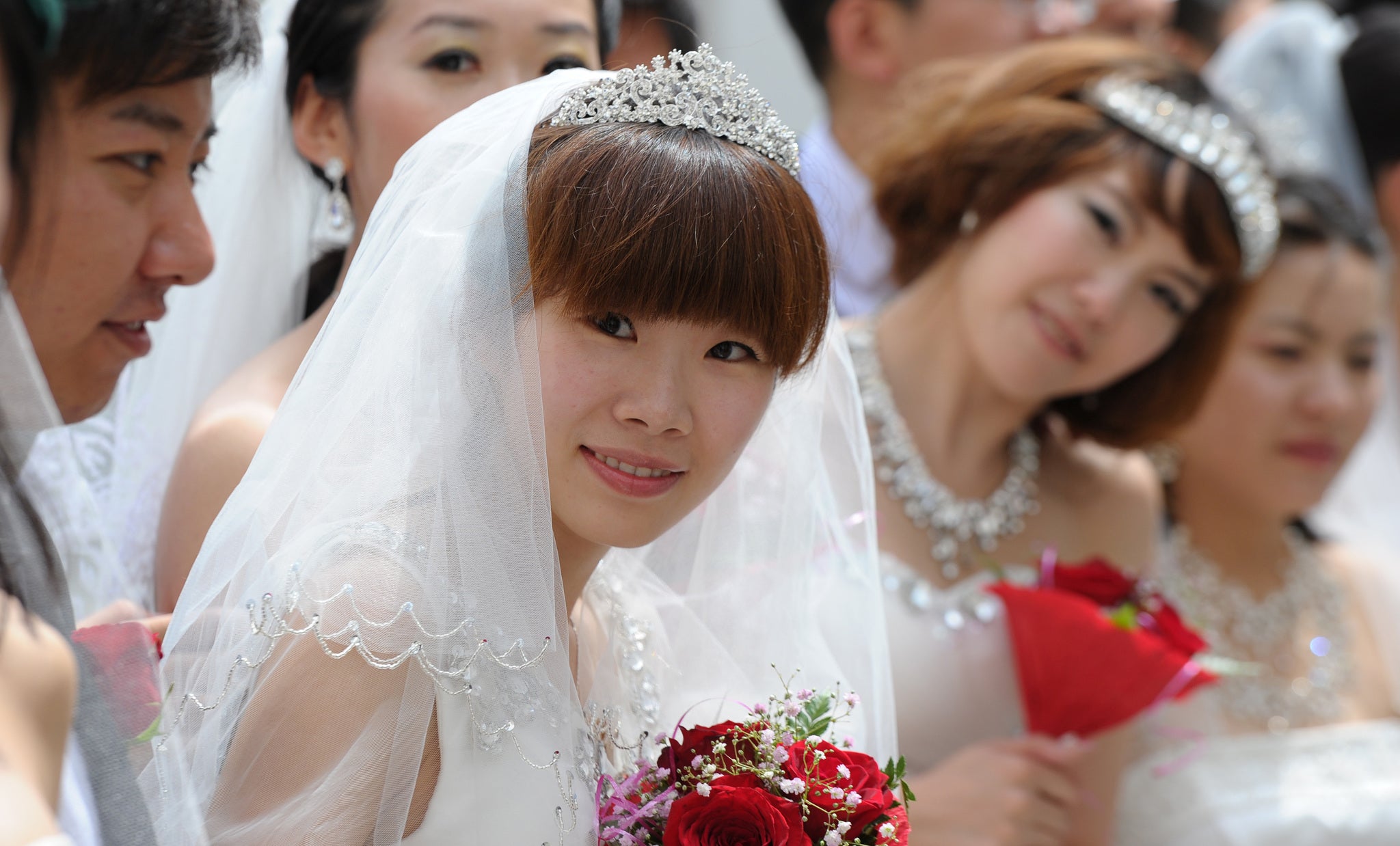 Thousands of newly graduated female students are deciding to wear wedding dresses for their graduation days