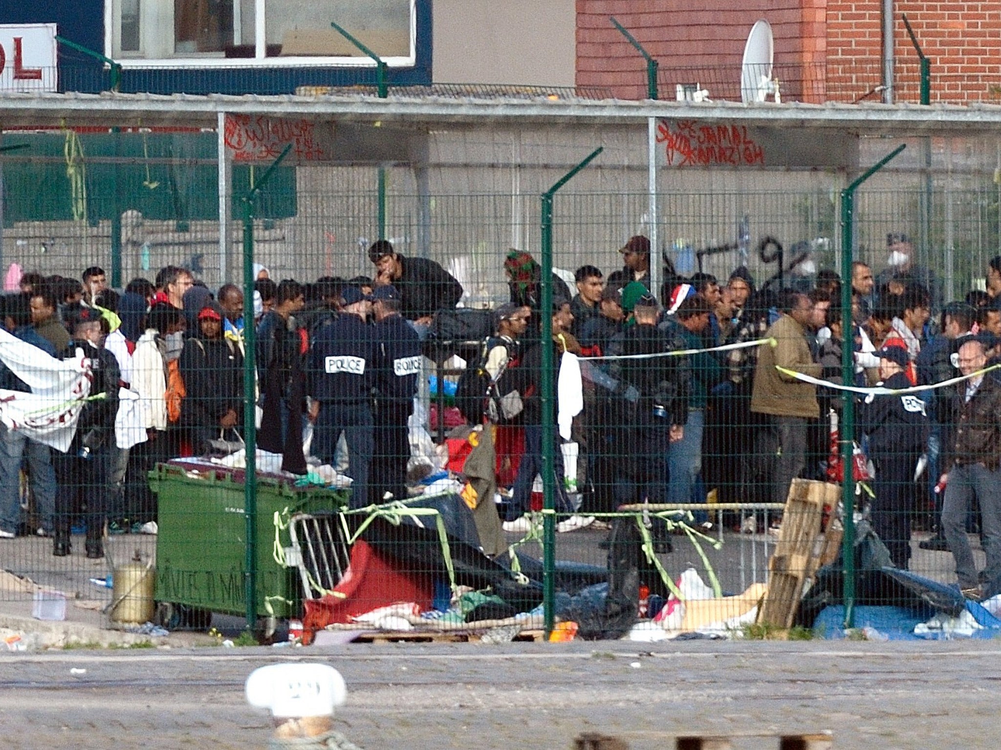 French policemen expel illegal migrants from their camp in Calais (Getty)