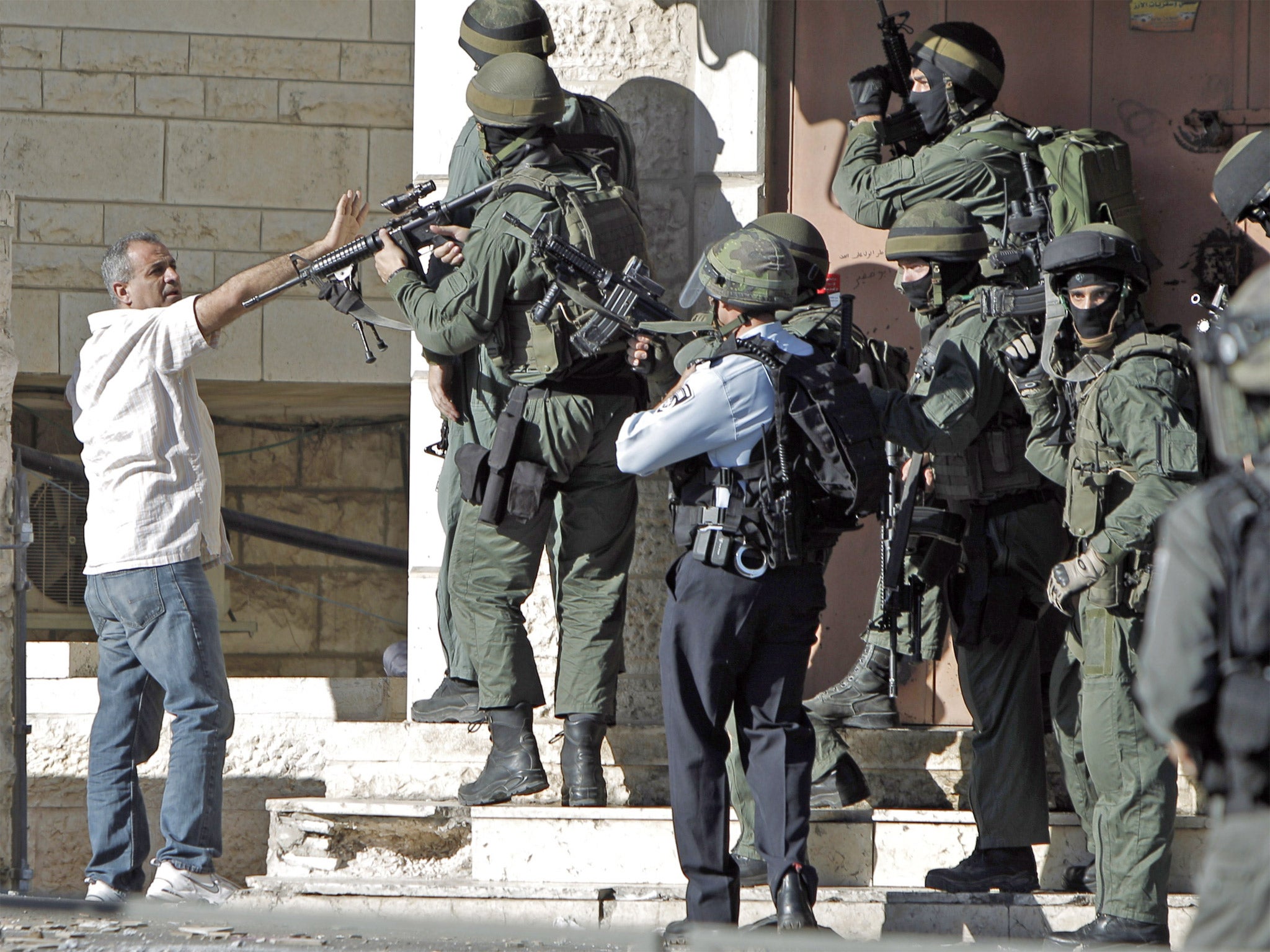 Israeli security and a Palestinian stone thrower clash in the Shuafat neighborhood in Israeli-annexed Arab East Jerusalem