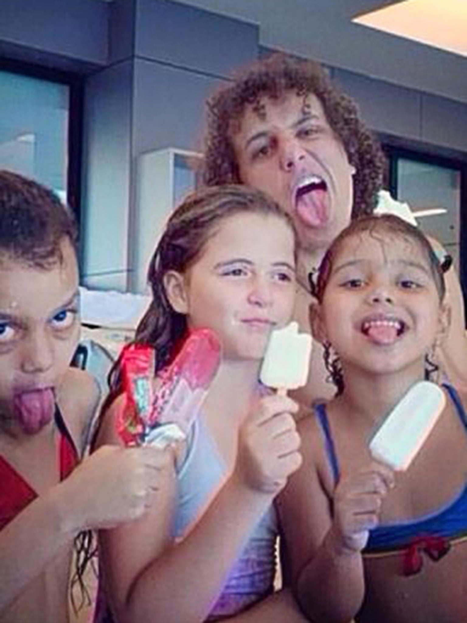 David Luiz posing with kids at a swimming pool