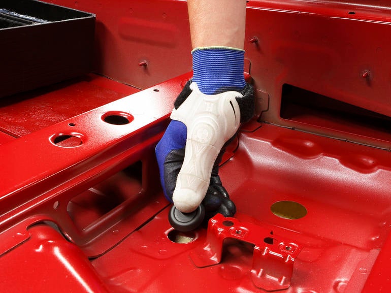 The 3D-printed thumb lets workers push in rubber plugs with less strain.