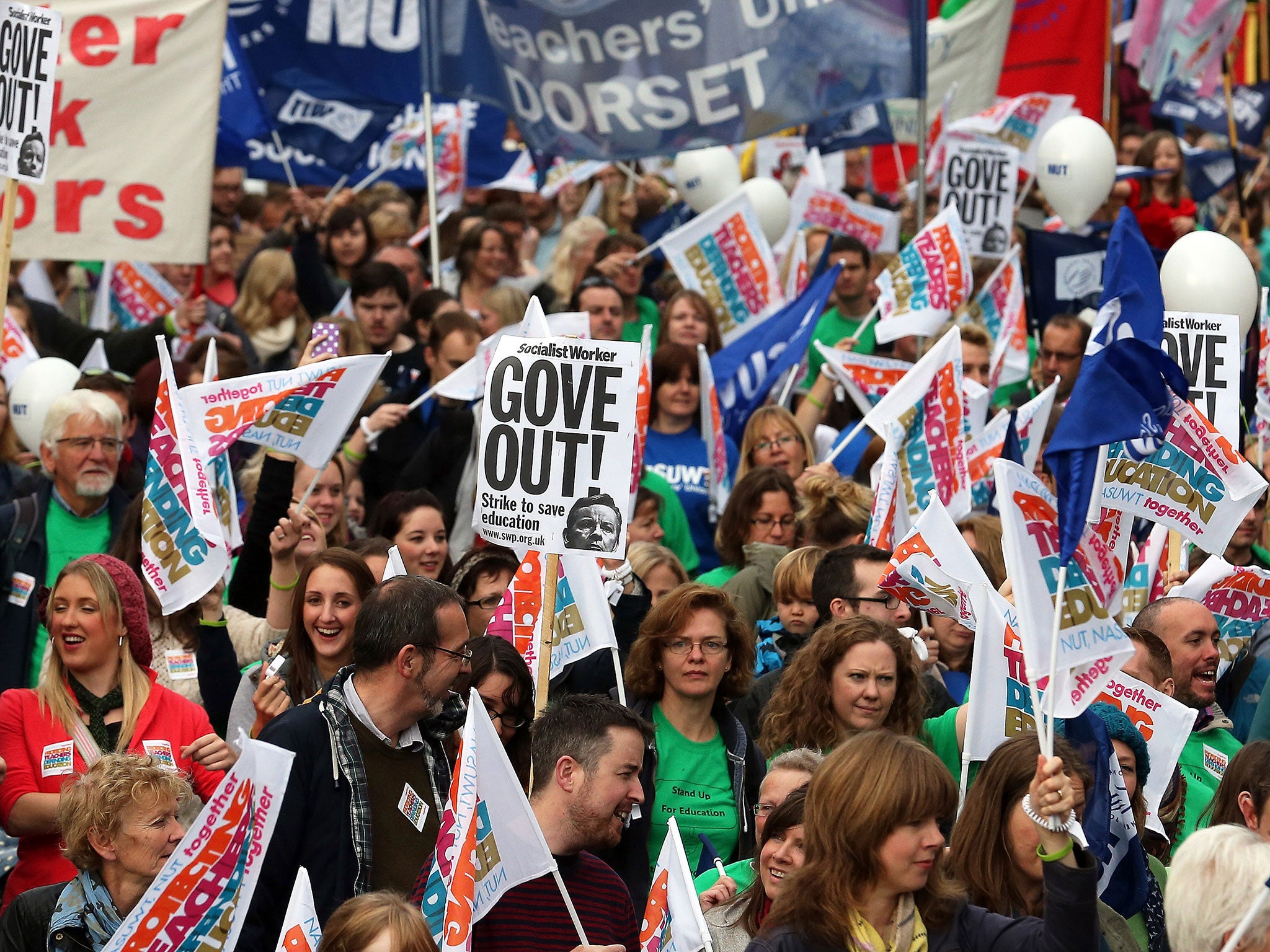 Protesters march during a one-day strike in March 2014