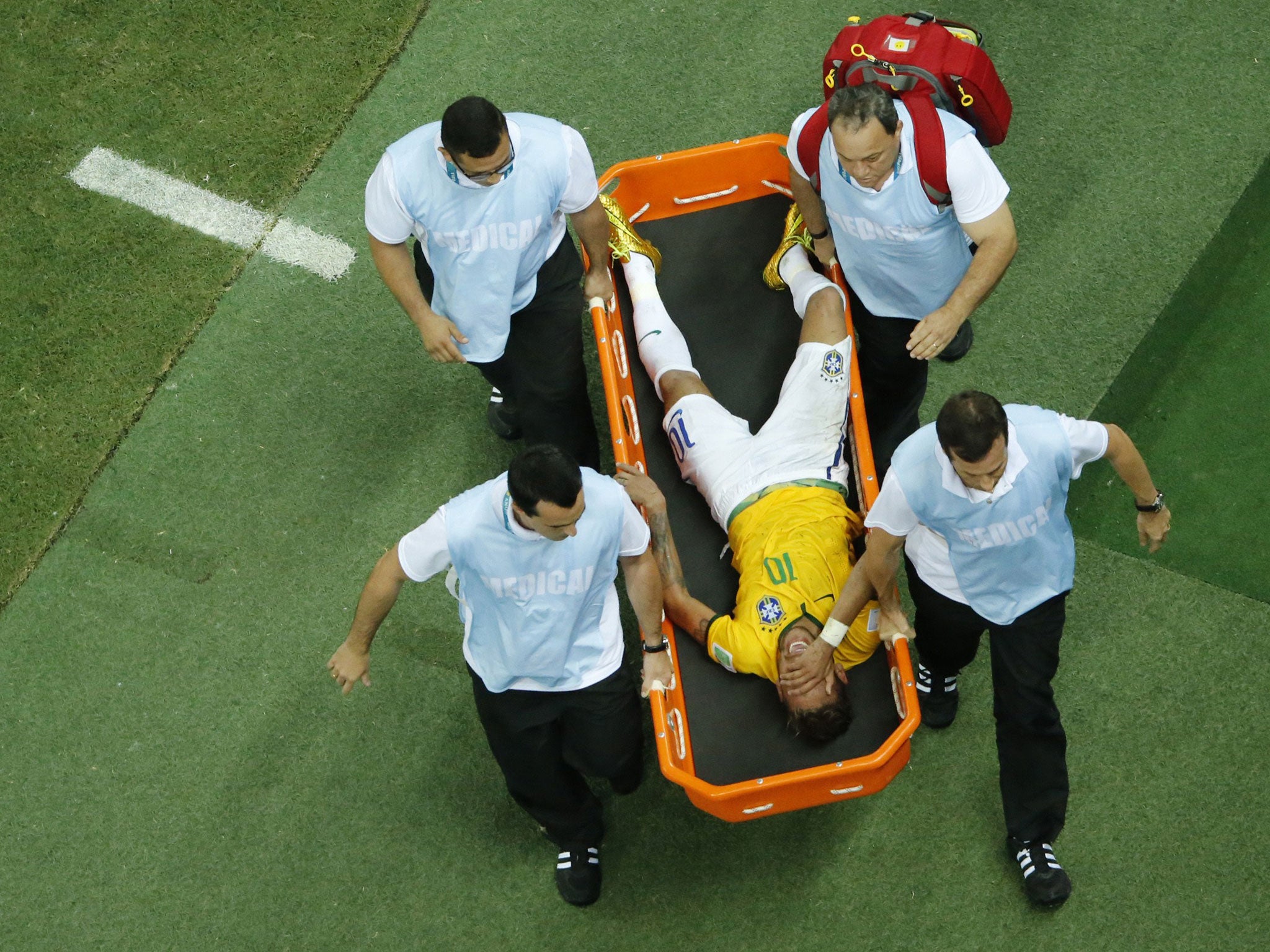 Brazil's forward Neymar is carried on a stretcher after being injured during the quarter-final football match between Brazil and Colombia