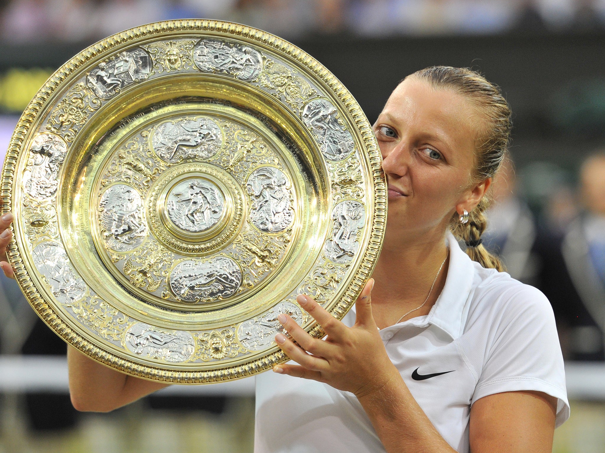 Petra Kvitova kisses the winner's Venus Rosewater Dish during the presentation after beating Eugenie Bouchard