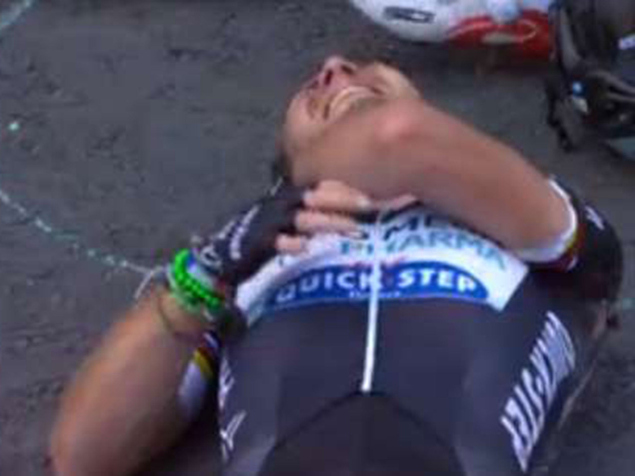 Cavendish holds his collarbone as he is clearly in pain