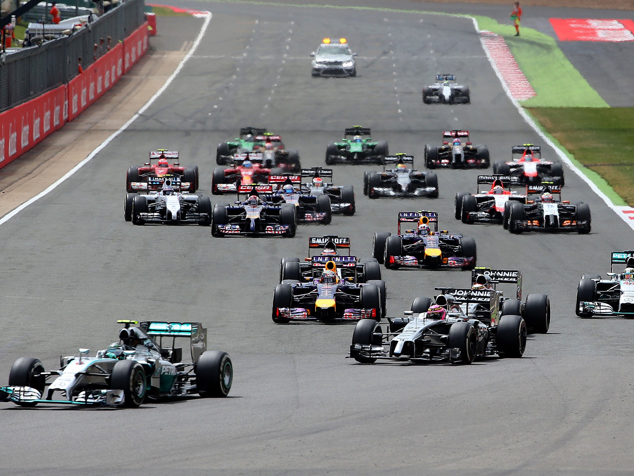 Nico Rosberg leads the field away at the start, with Lewis Hamilton just off-shot to the right and Felipe Massa left lagging at the back