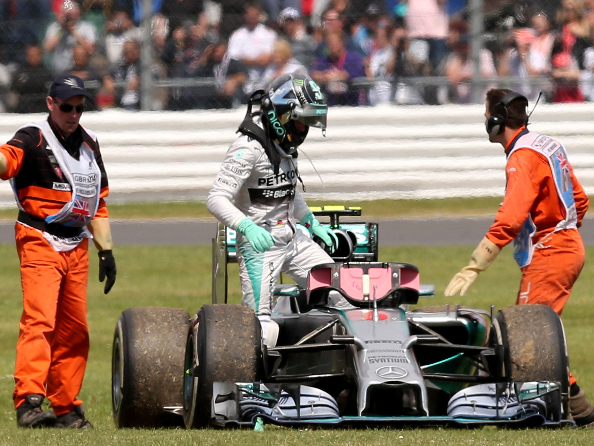 Nico Rosberg climbs out of his stricken Mercedes after a gearbox failure saw him stuck in fifth