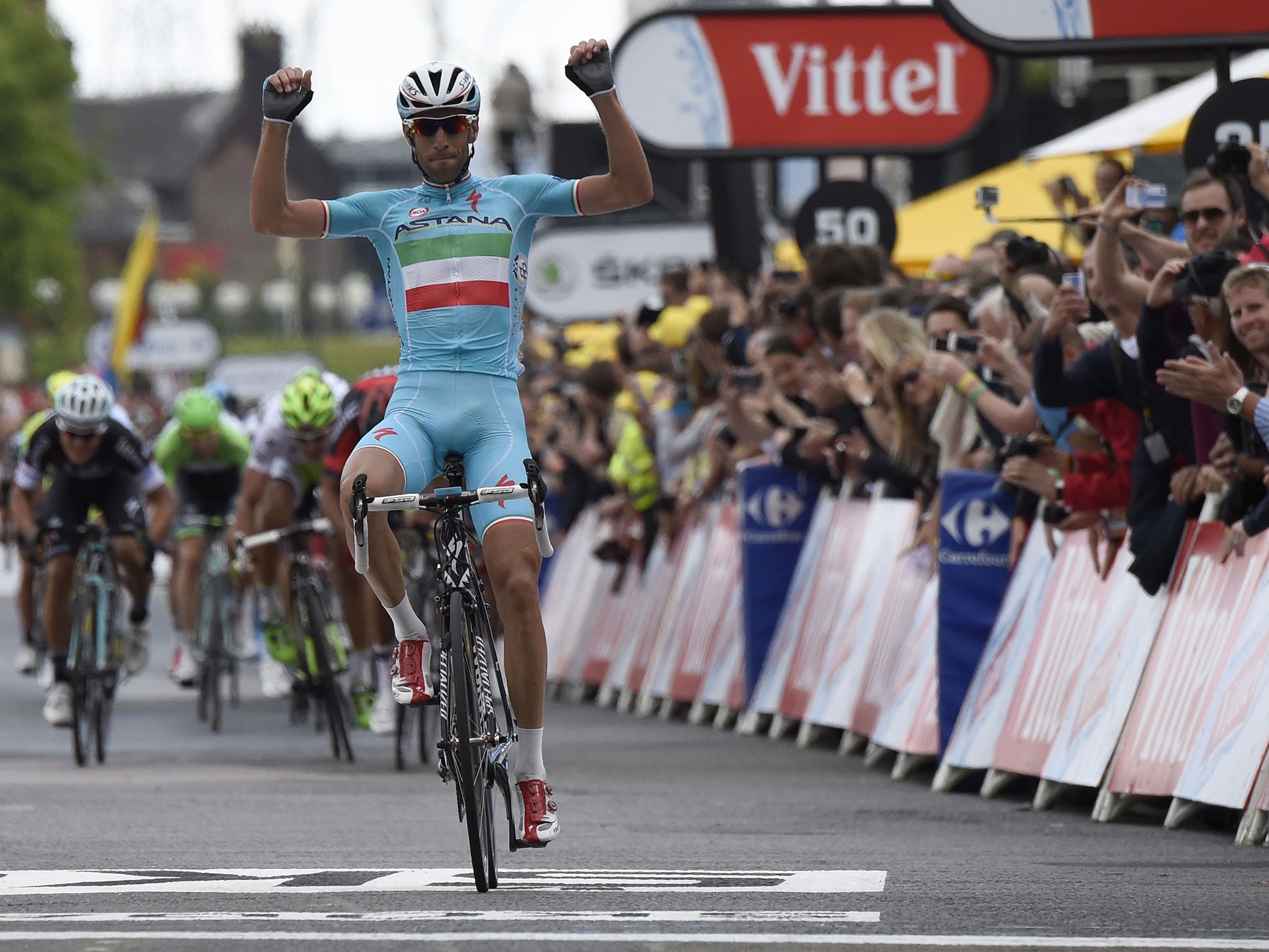 Italy's Vincenzo Nibali celebrates as he crosses the finish line at the end of the 201 km second stage of the 101th edition of the Tour de France cycling race on July 6, 2014 between York and Sheffield